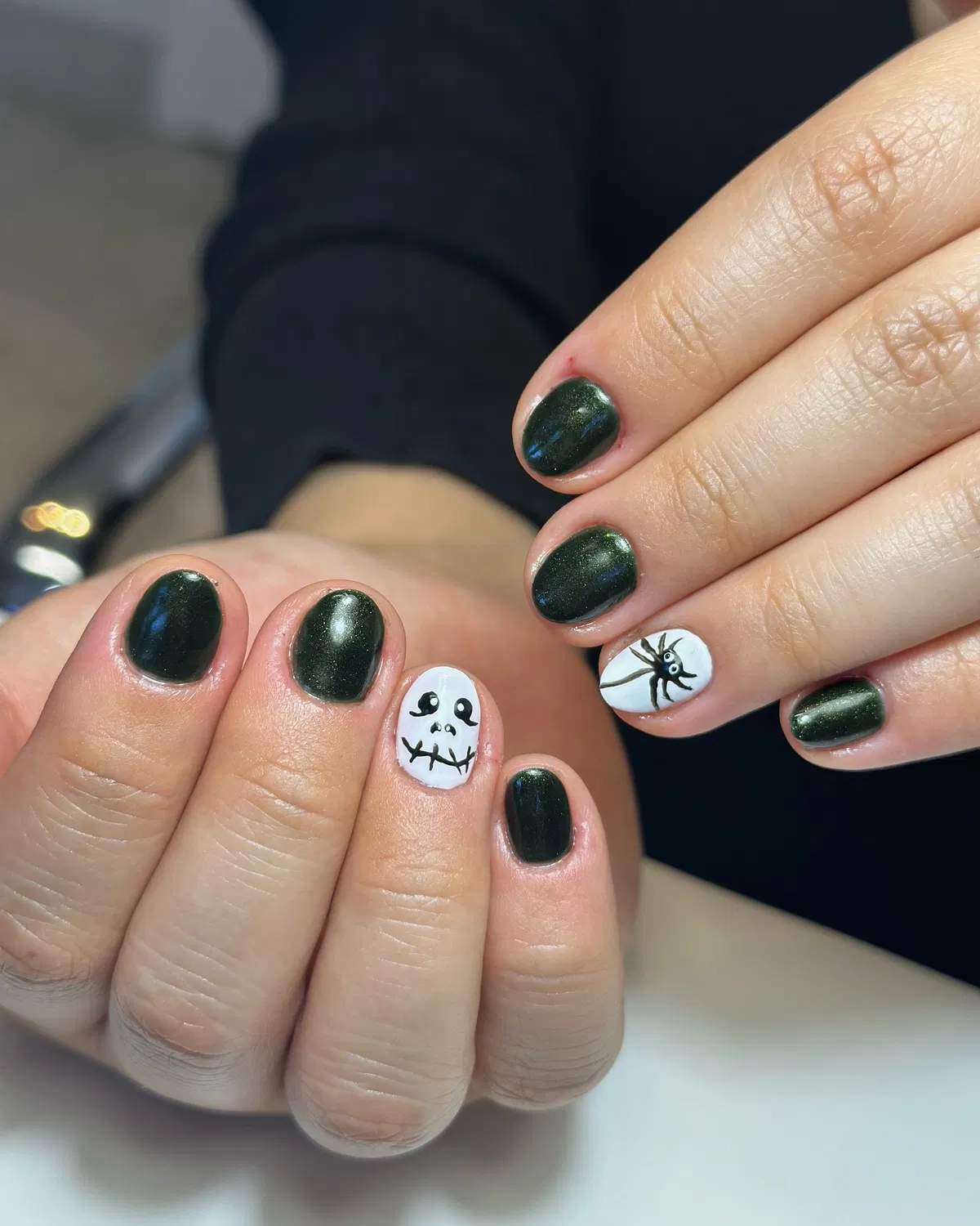 Dark shimmer nails with white spooky accents
