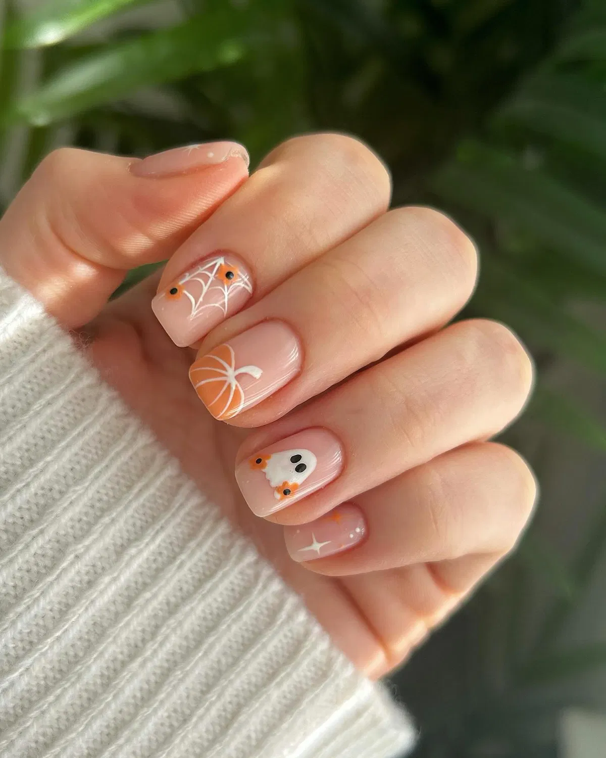 Minimal nude set with web, ghost, and orange corner details