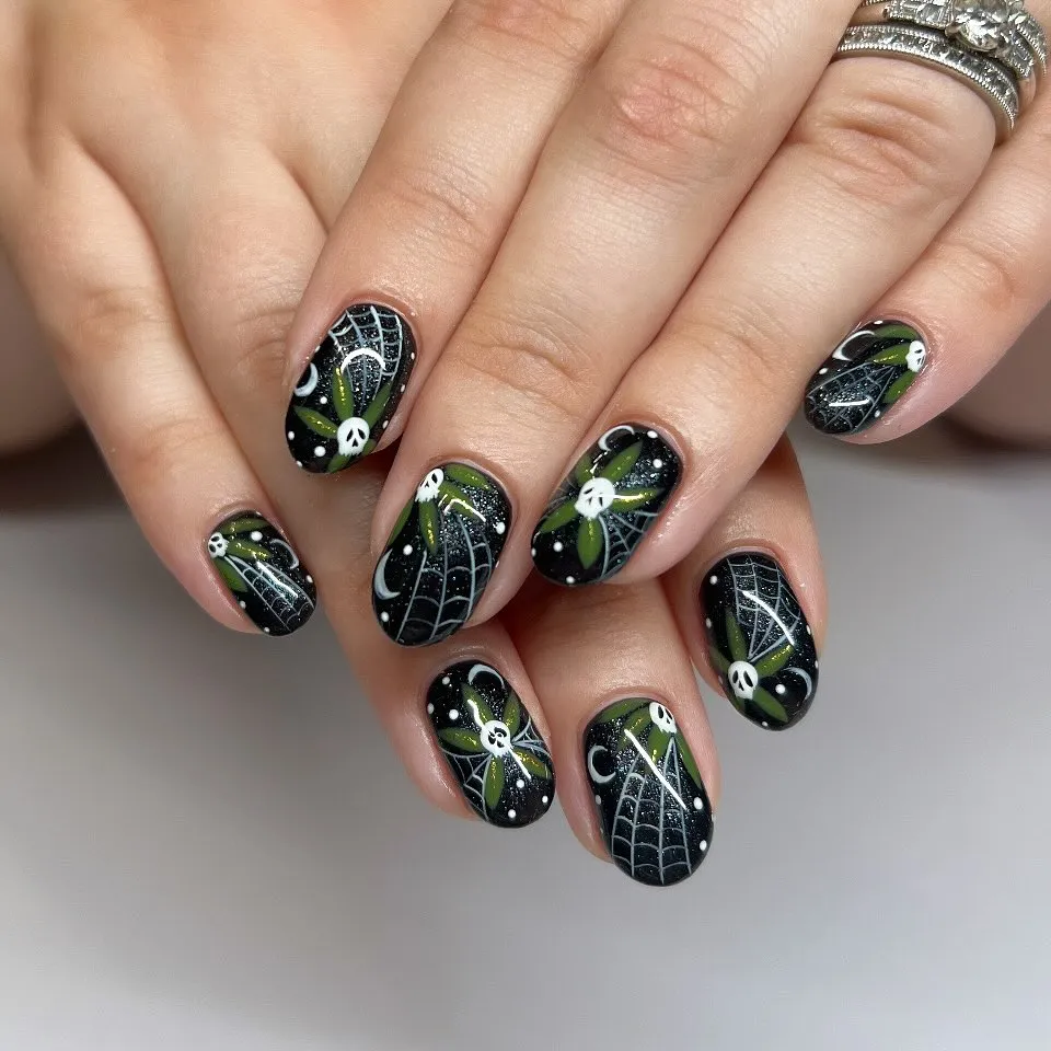 Black glossy set with white webs, skulls, and green leaf accents