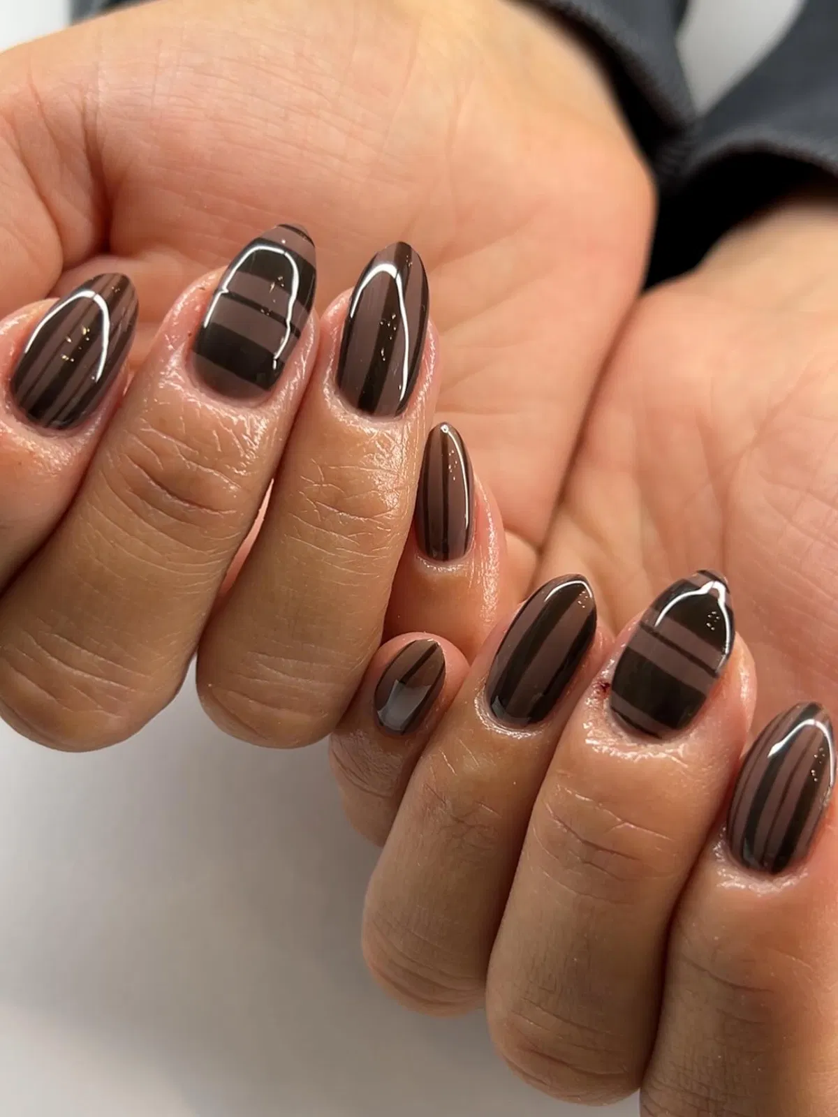 Glossy dark brown with tonal horizontal striping