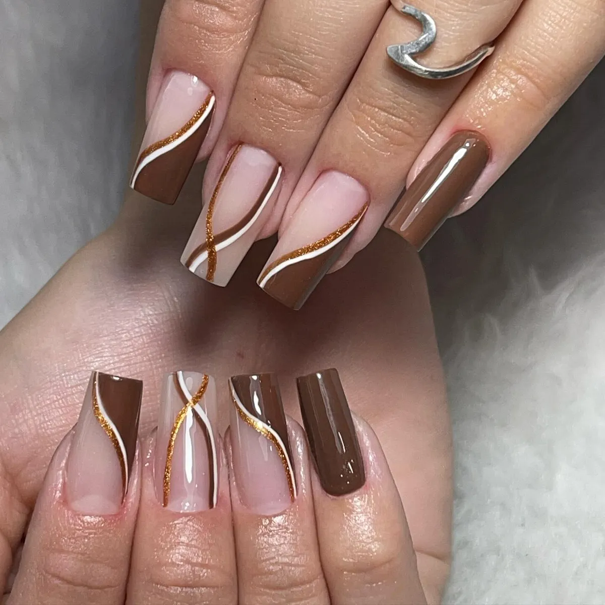 Nude and brown curves with white lines and gold glitter accents