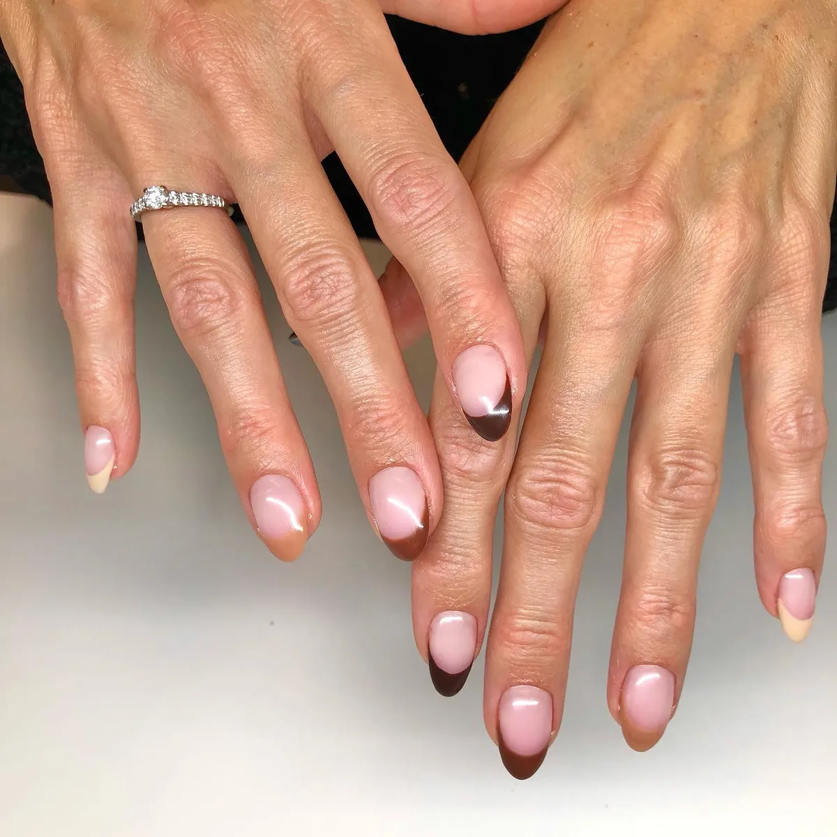 Glossy nude base with dark brown French tips