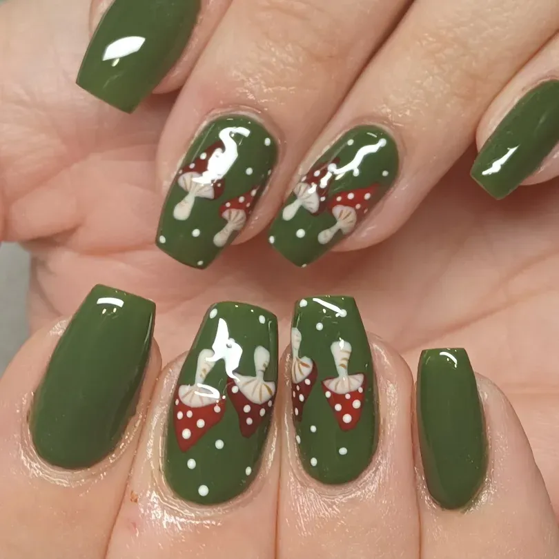 Olive green nails with red-and-white mushroom art