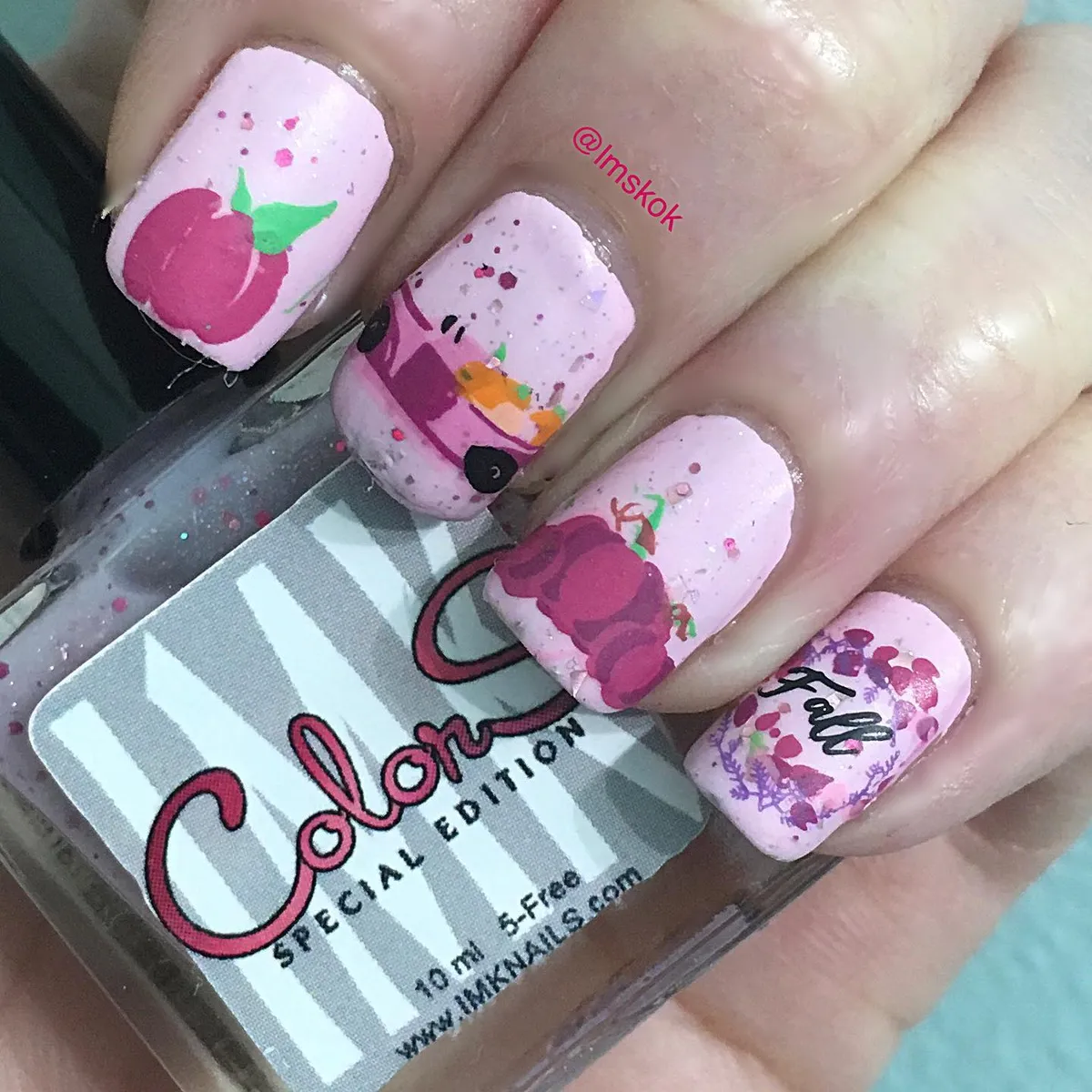 Light pink speckled nails with illustrated accents and โfallโ text