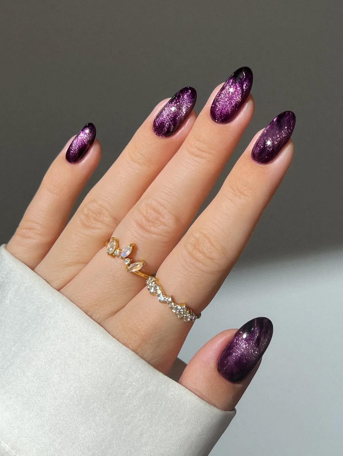 Glittery plum-purple shimmer on almond nails