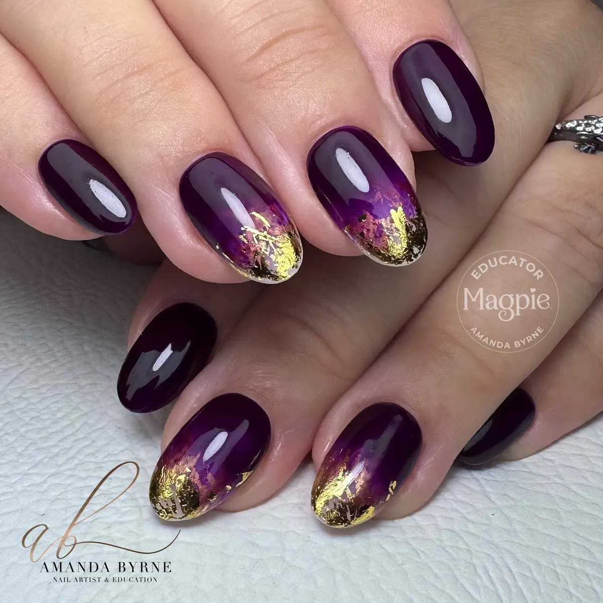Deep plum gloss with irregular gold foil-style tips