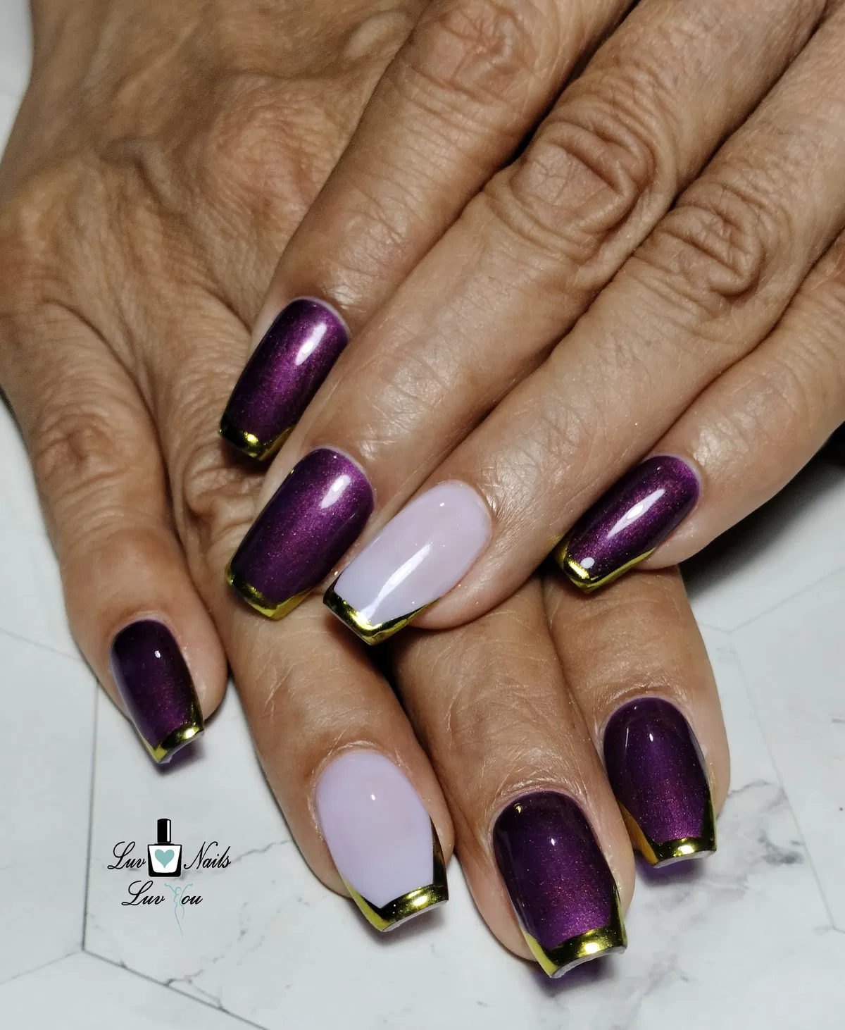 Deep plum shimmer with metallic gold French tips