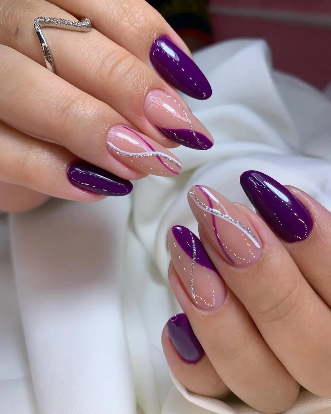 Deep plum almonds with nude-and-silver curved line accents