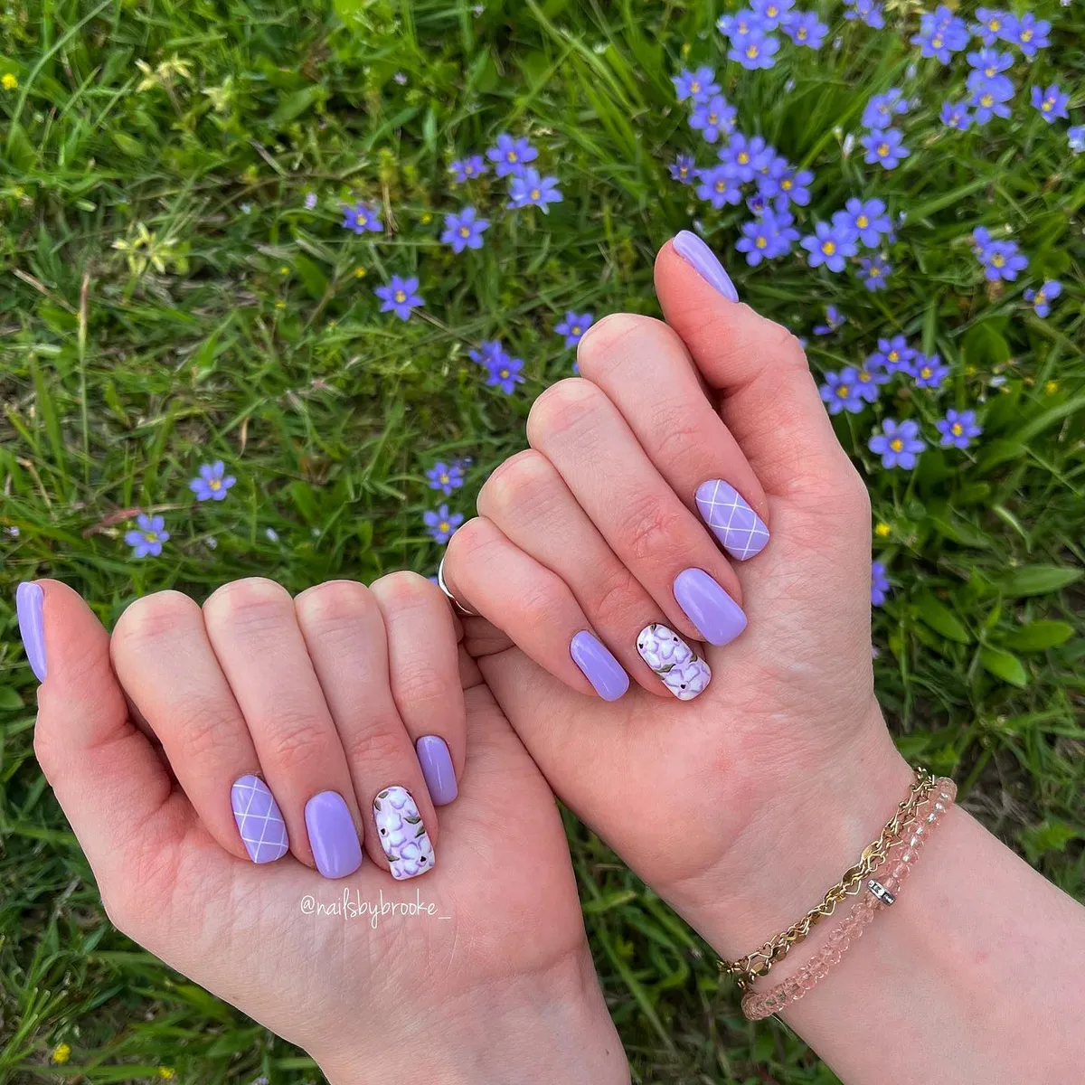 Lavender nails with lattice and floral accents (outdoor background)