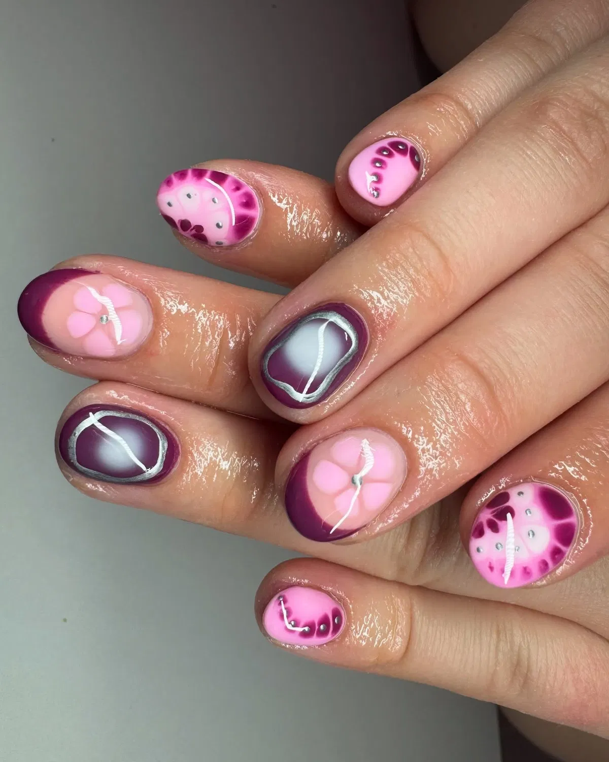 Short plum French curves with silver-outlined center accents