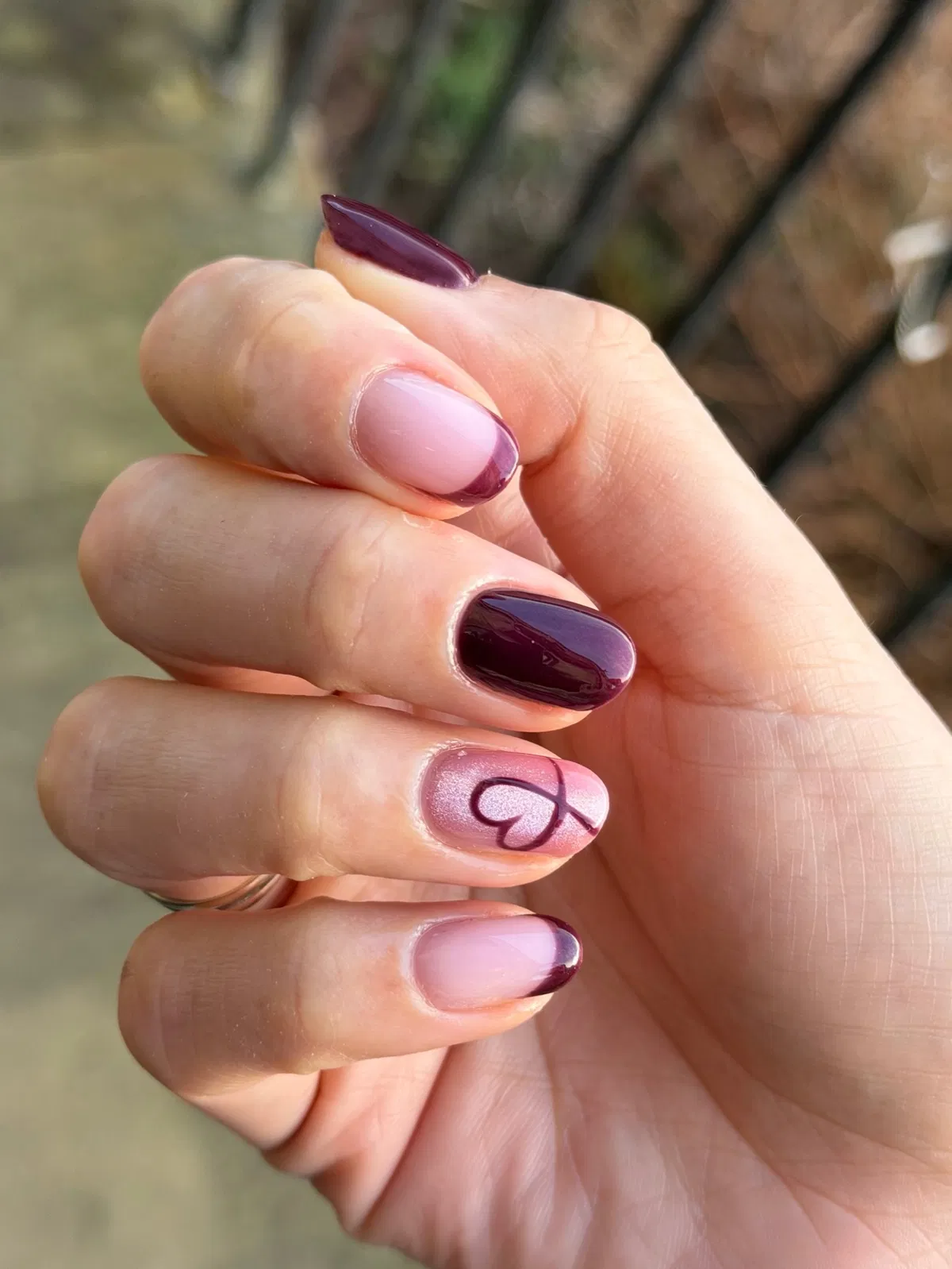 Deep plum tips with a heart outline accent