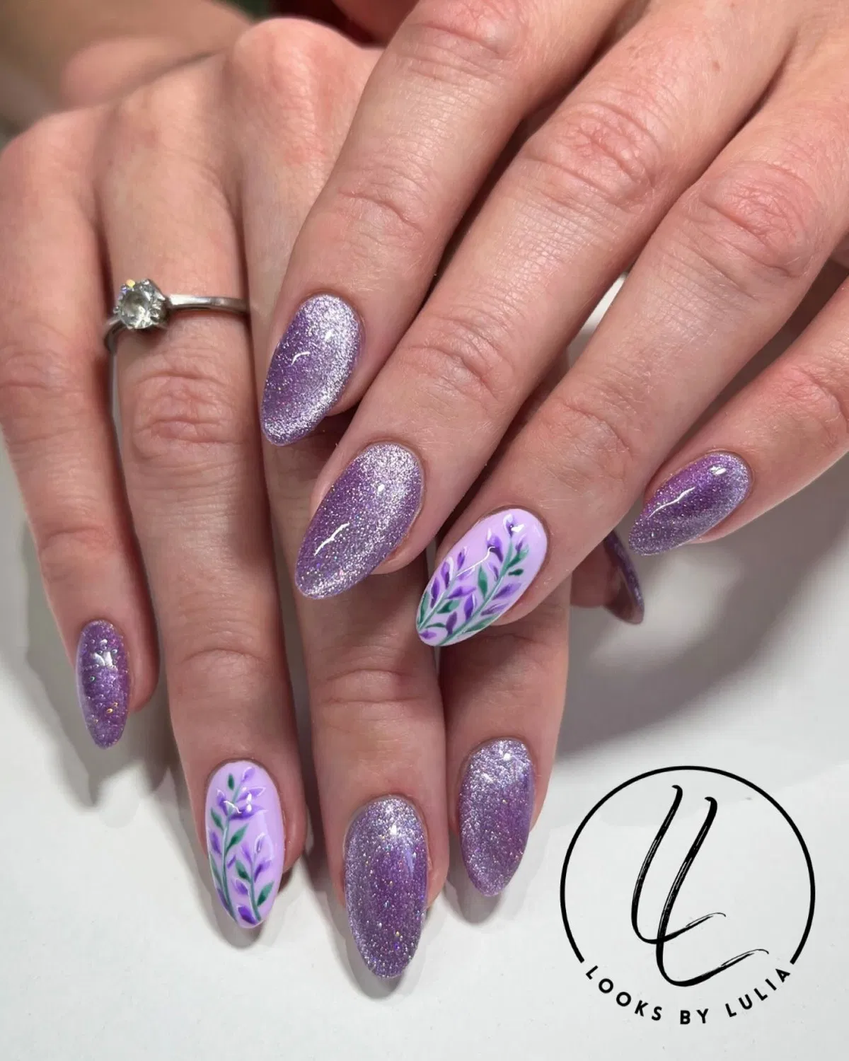 Glittery purple almonds with lilac floral accent nails