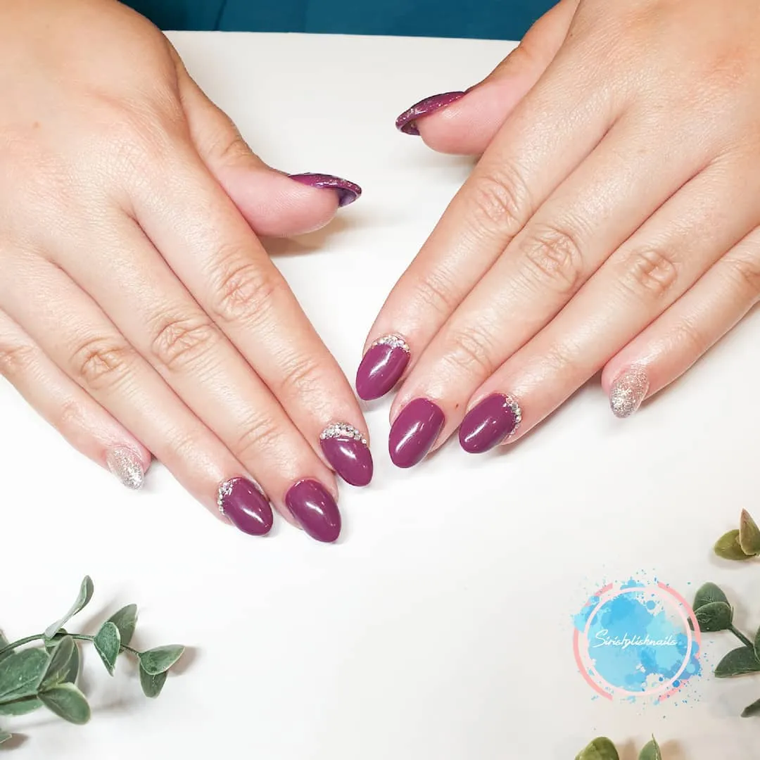 Glossy plum with rhinestone arcs and a silver glitter accent
