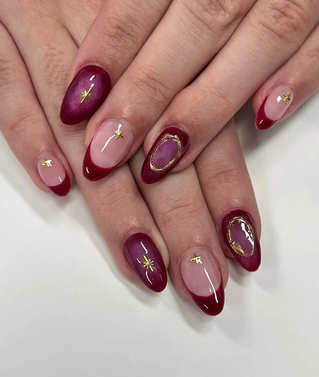 Wine French tips with gold star charms and framed ovals