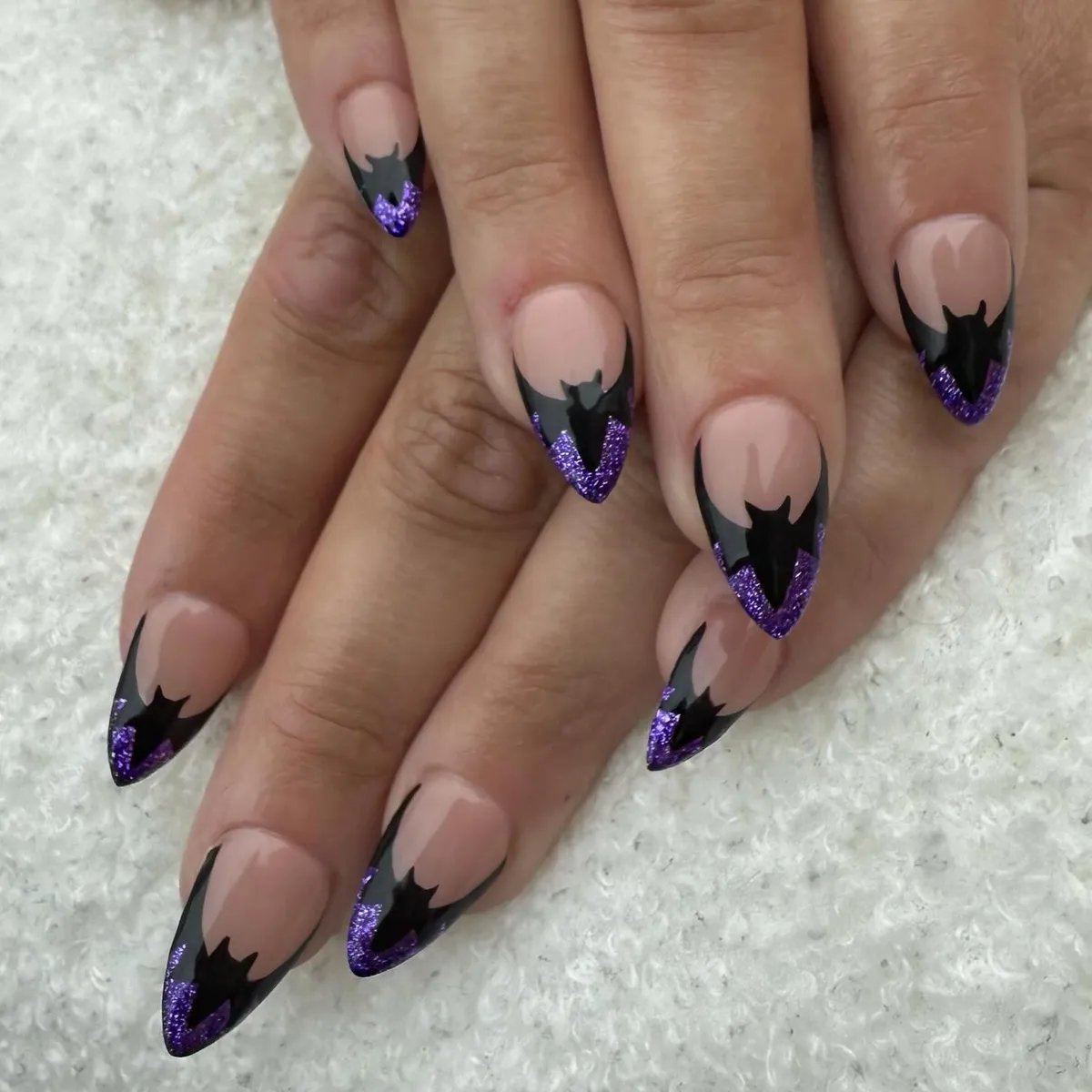 Bat-shaped tips with purple glitter French edges