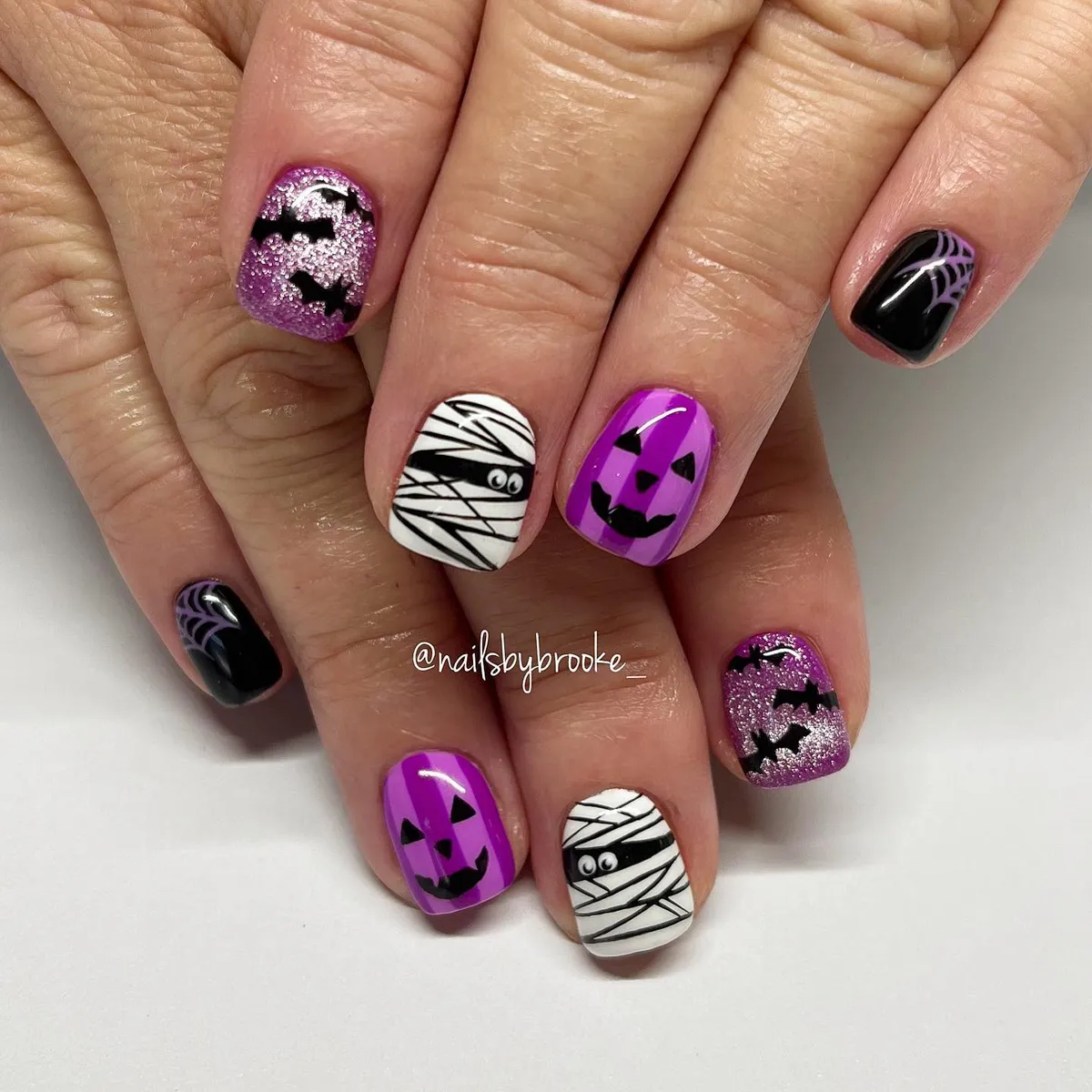 Purple jack-o'-lanterns, bats, and mummy wraps