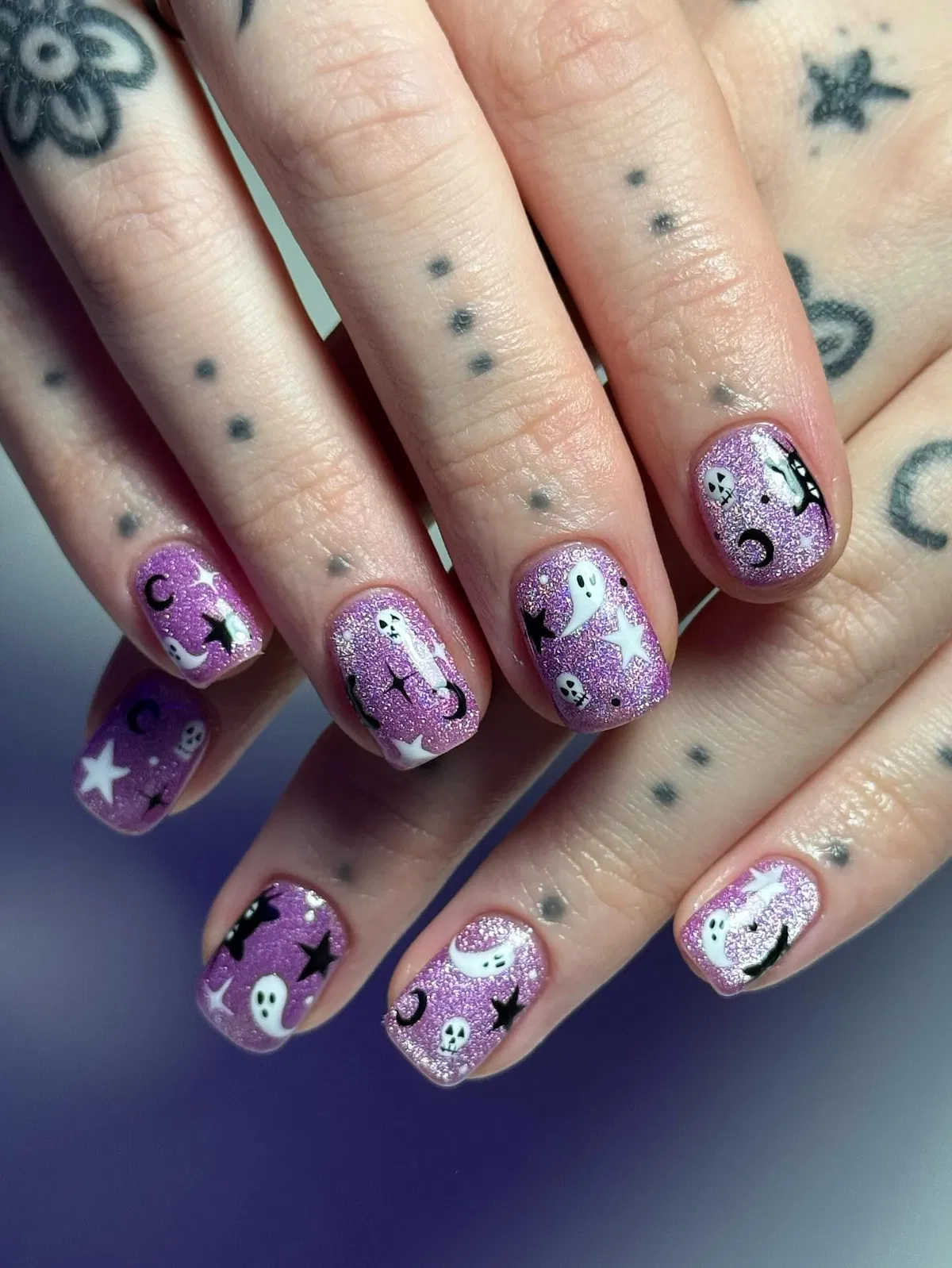 Purple glitter with ghosts, moons, stars, and skull motifs
