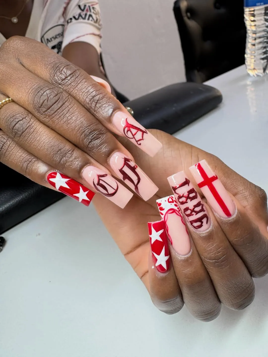 Long nude-and-red set with stars, cross, and gothic lettering