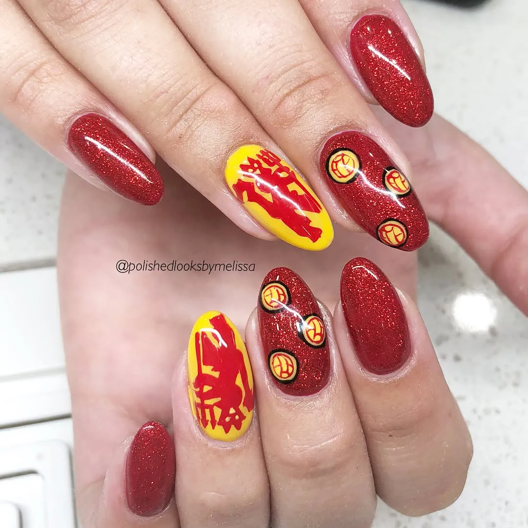 Red glitter almond nails with yellow graphic accent nails