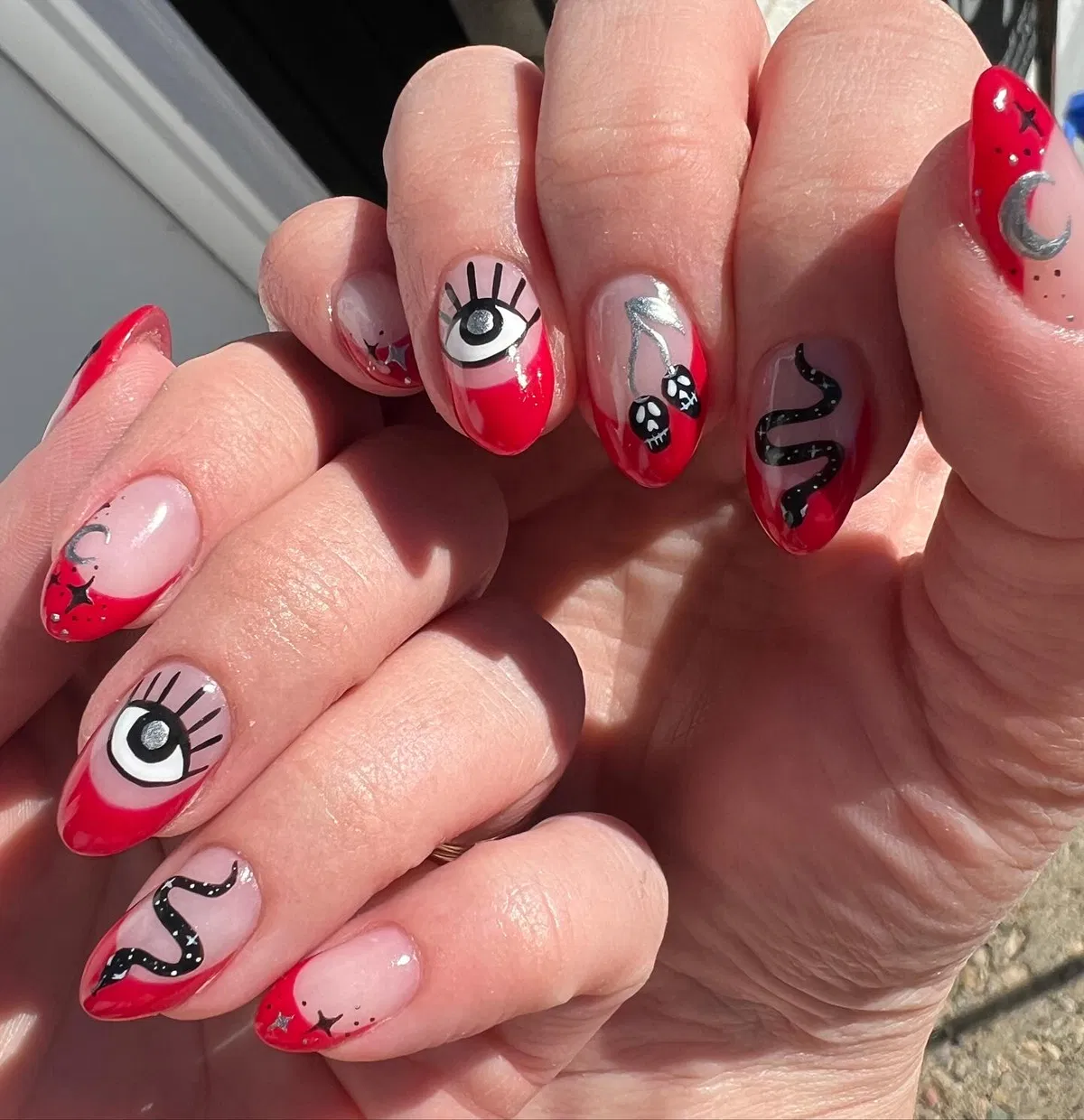 Red-tipped set with eyes, skulls, and snake motif