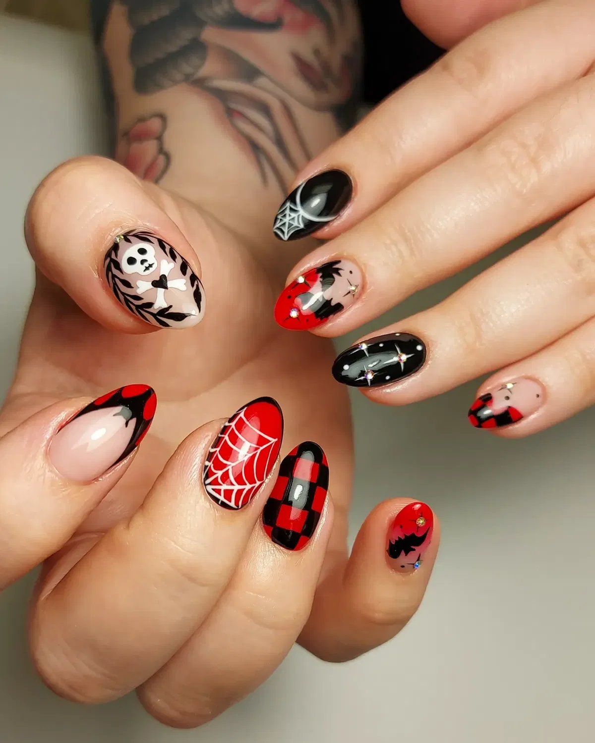 Red French tips with arrow lines and bat accents