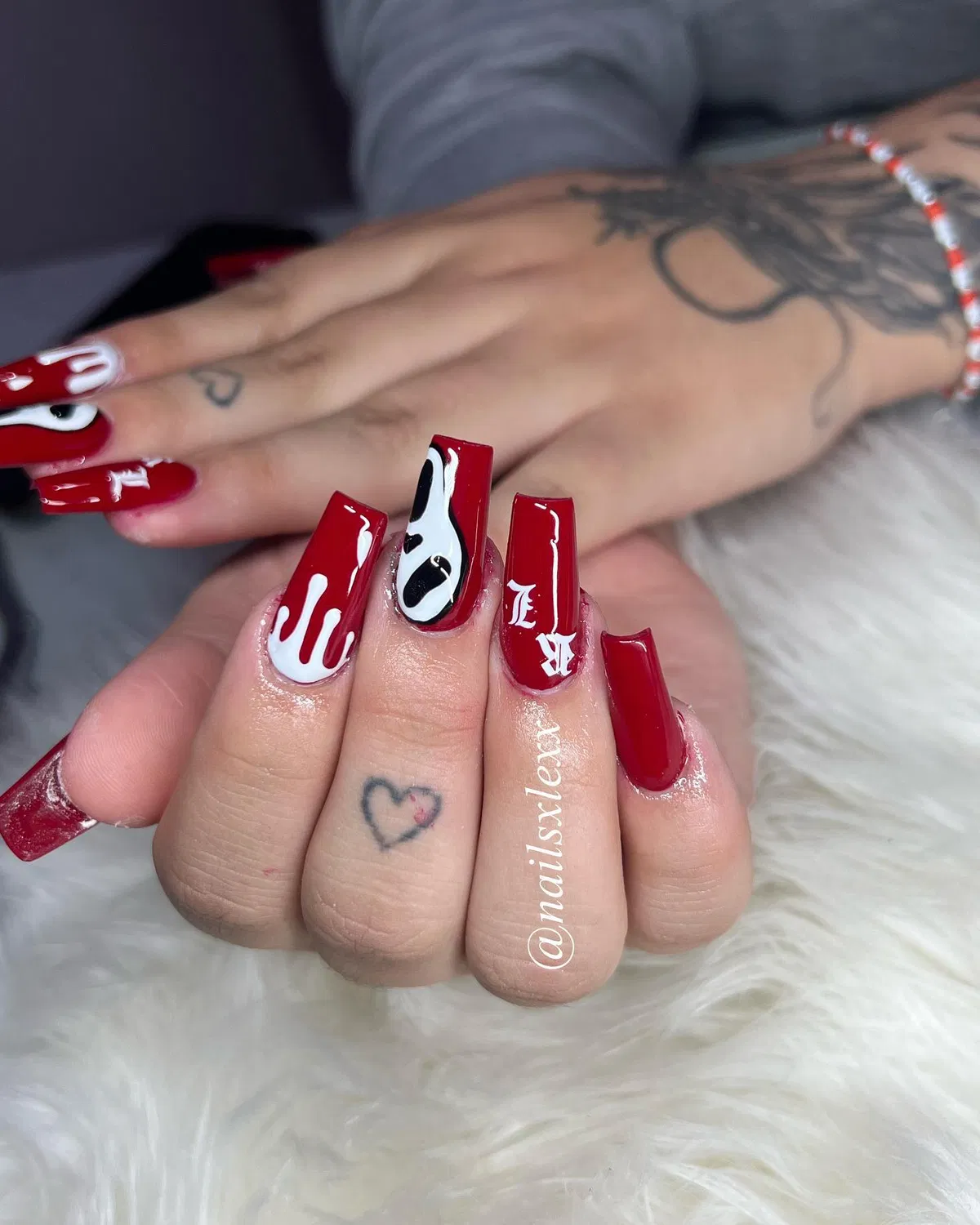 Glossy red coffin nails with drips and lettering