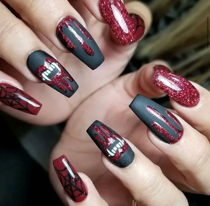 Matte black with red glitter drips and fang mouth art