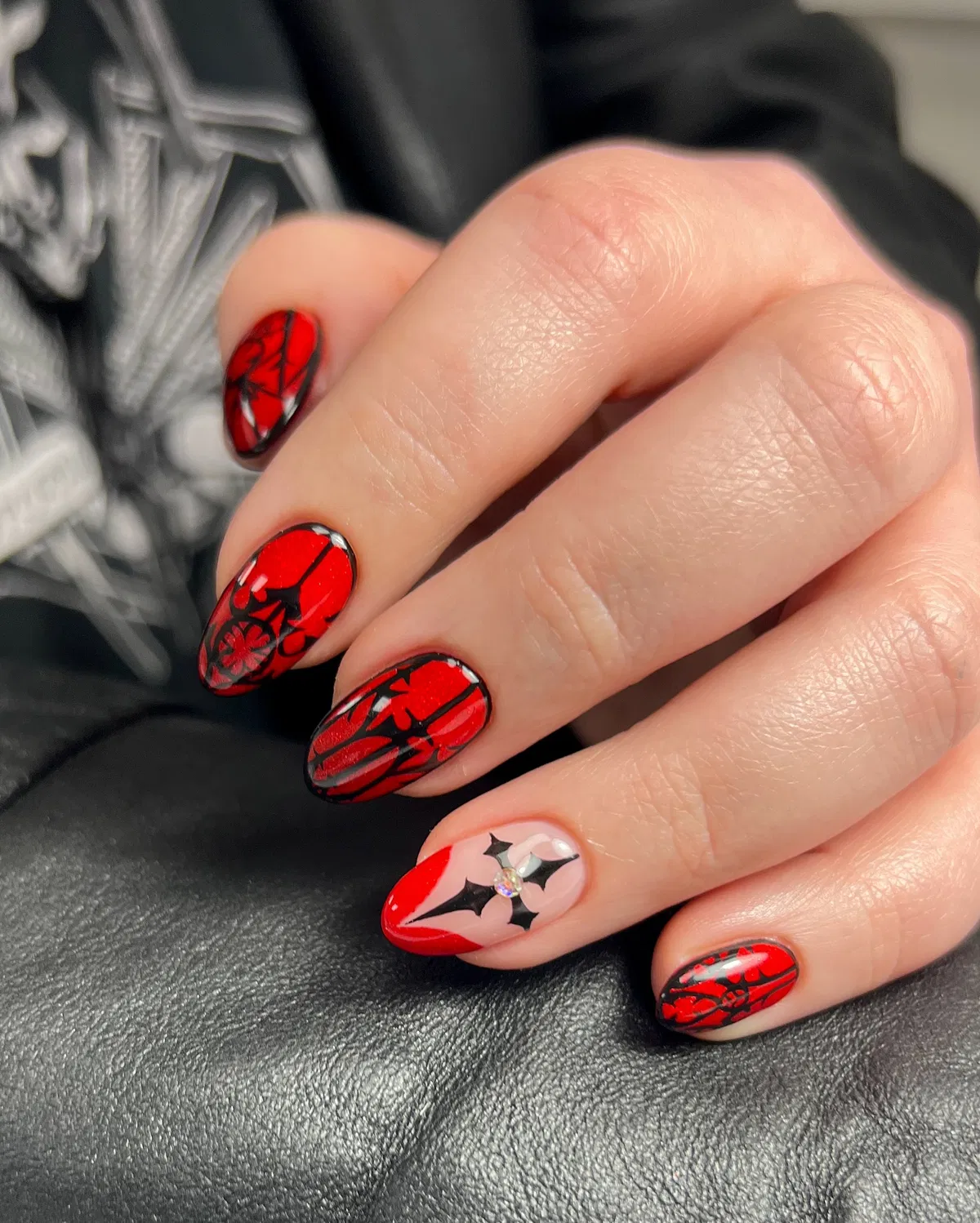 Red-and-black ornamental print with rhinestone accent