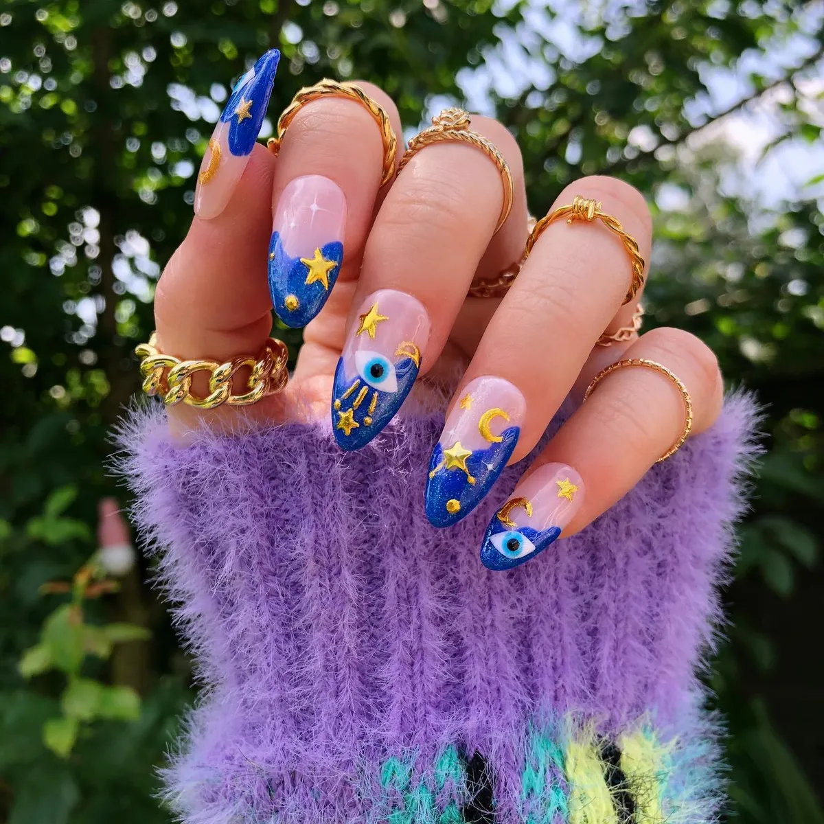 Blue tips with gold stars, moons, and eye accents