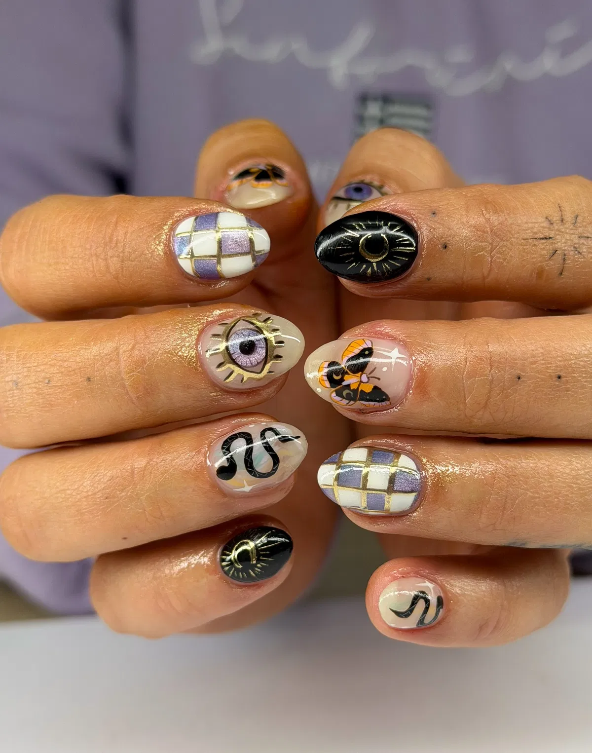 Mixed mini motifs: checks, crescent rays, eye, snake, and moth