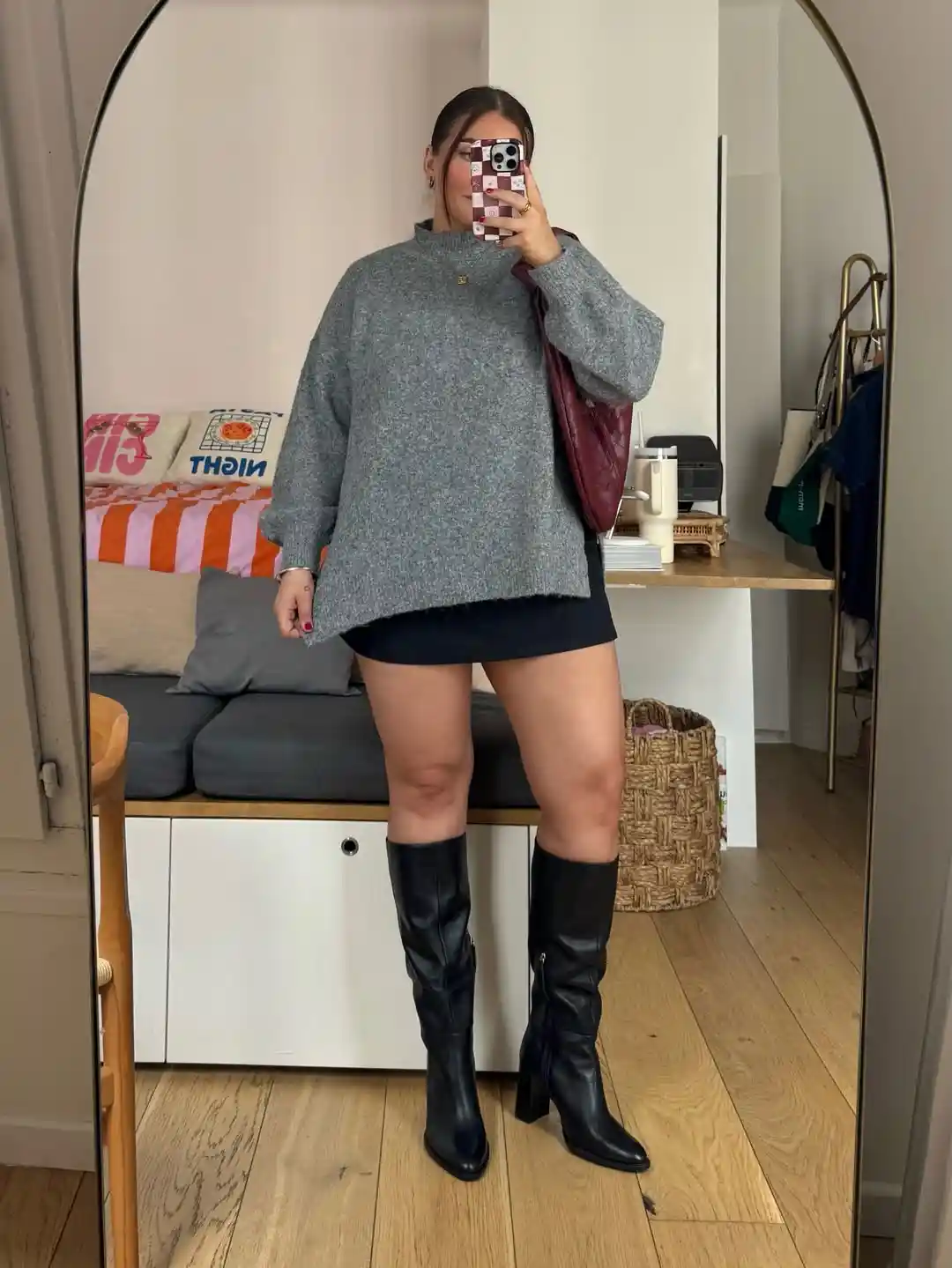 Oversized gray sweater with black mini and knee-high heeled boots