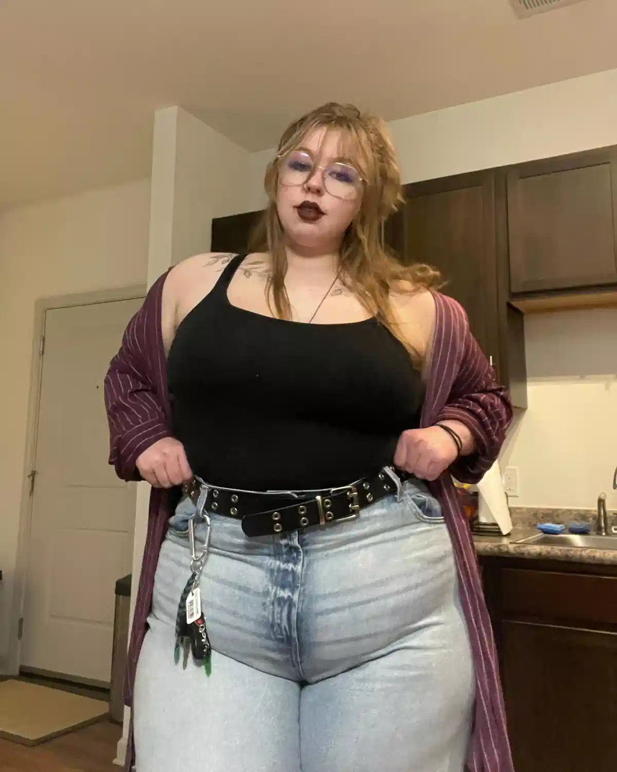Black tank with striped burgundy cardigan and grommet belt