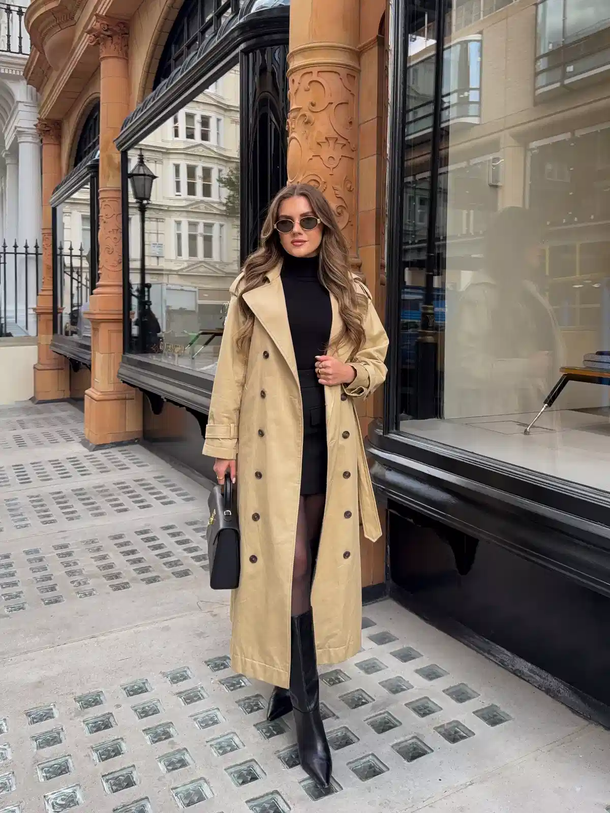Beige trench over black mini with knee-high boots
