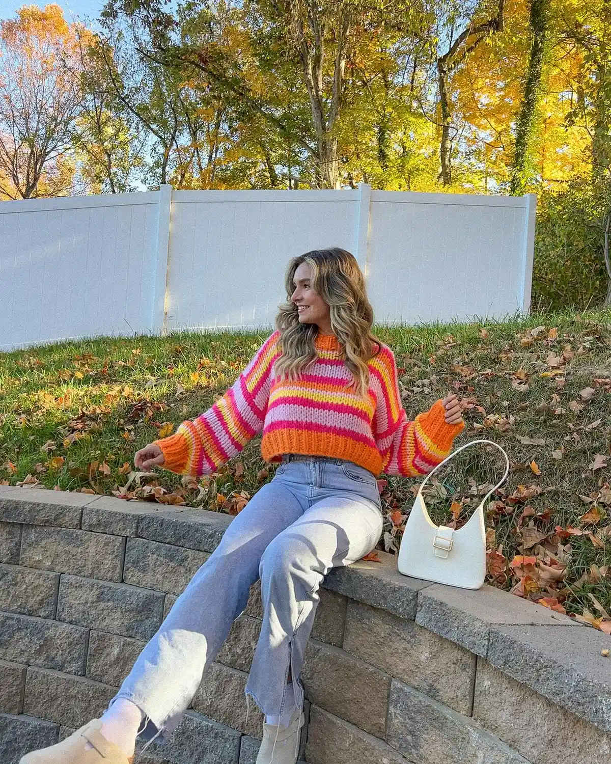 Bright striped sweater with light flared jeans