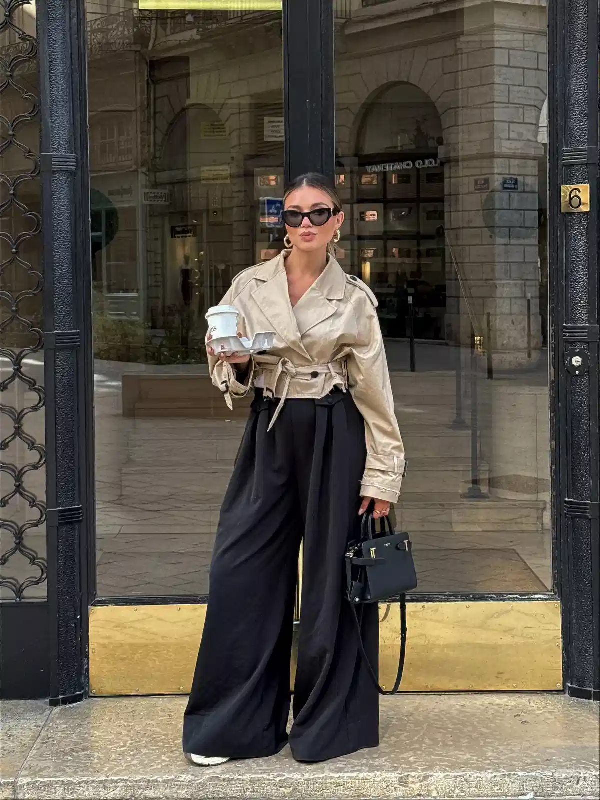 Cropped beige trench jacket with wide-leg black trousers