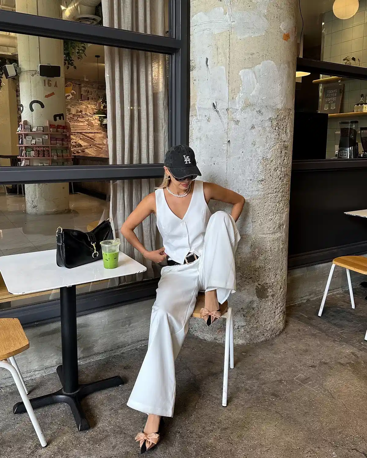 White vest-and-trouser set with black "LA" cap