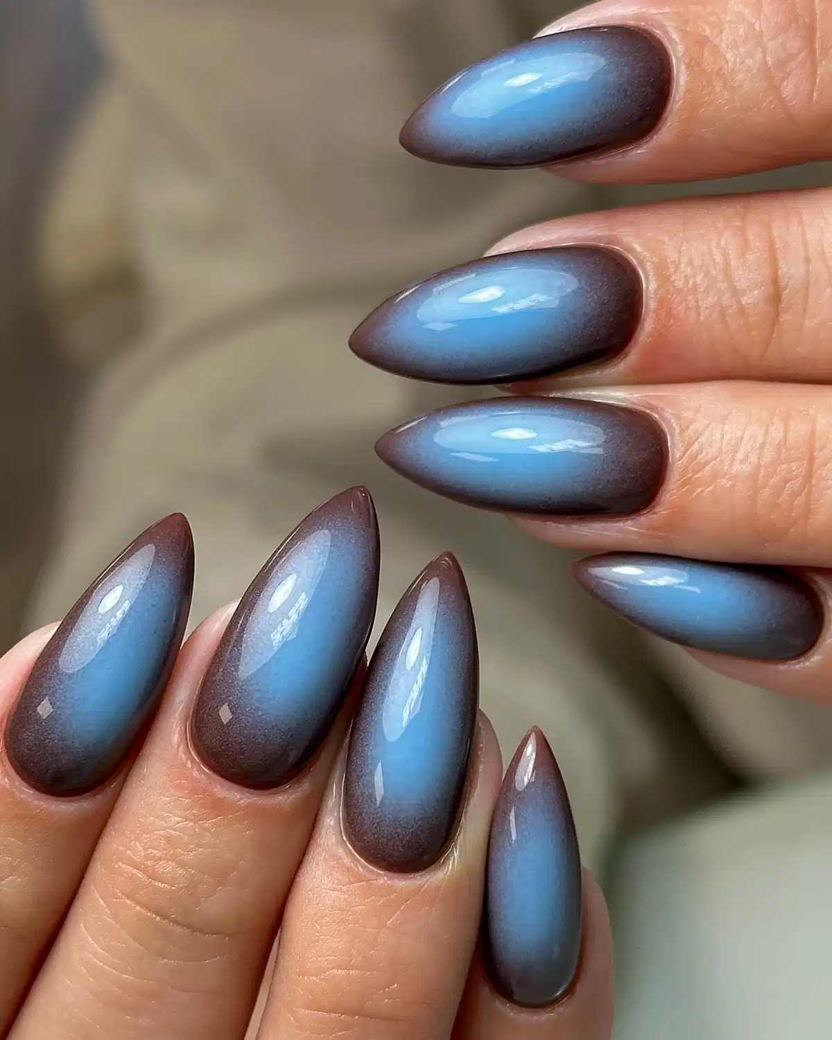 Glossy blue-to-brown ombre stiletto nails