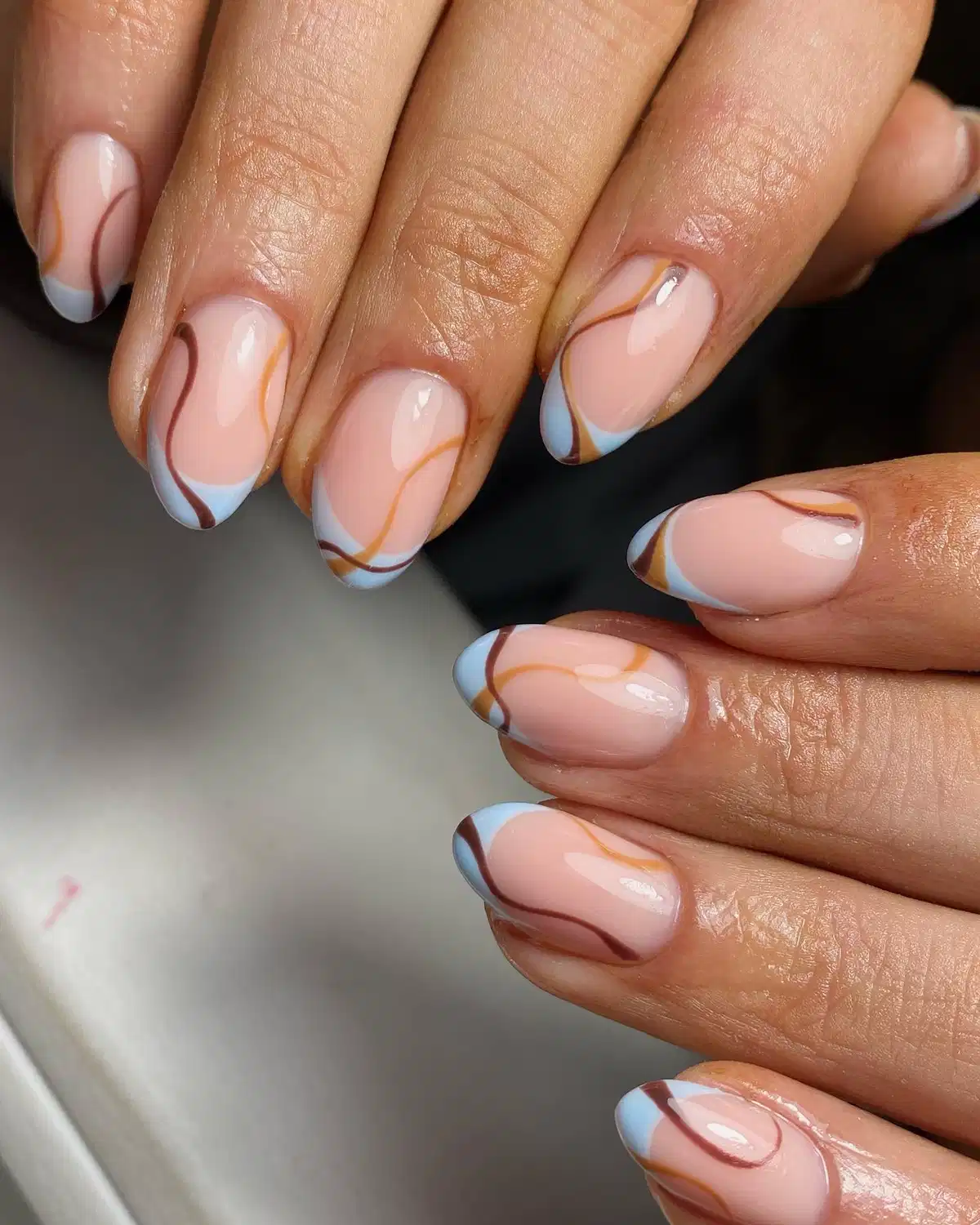 Nude pink with light-blue tips and wavy brown lines