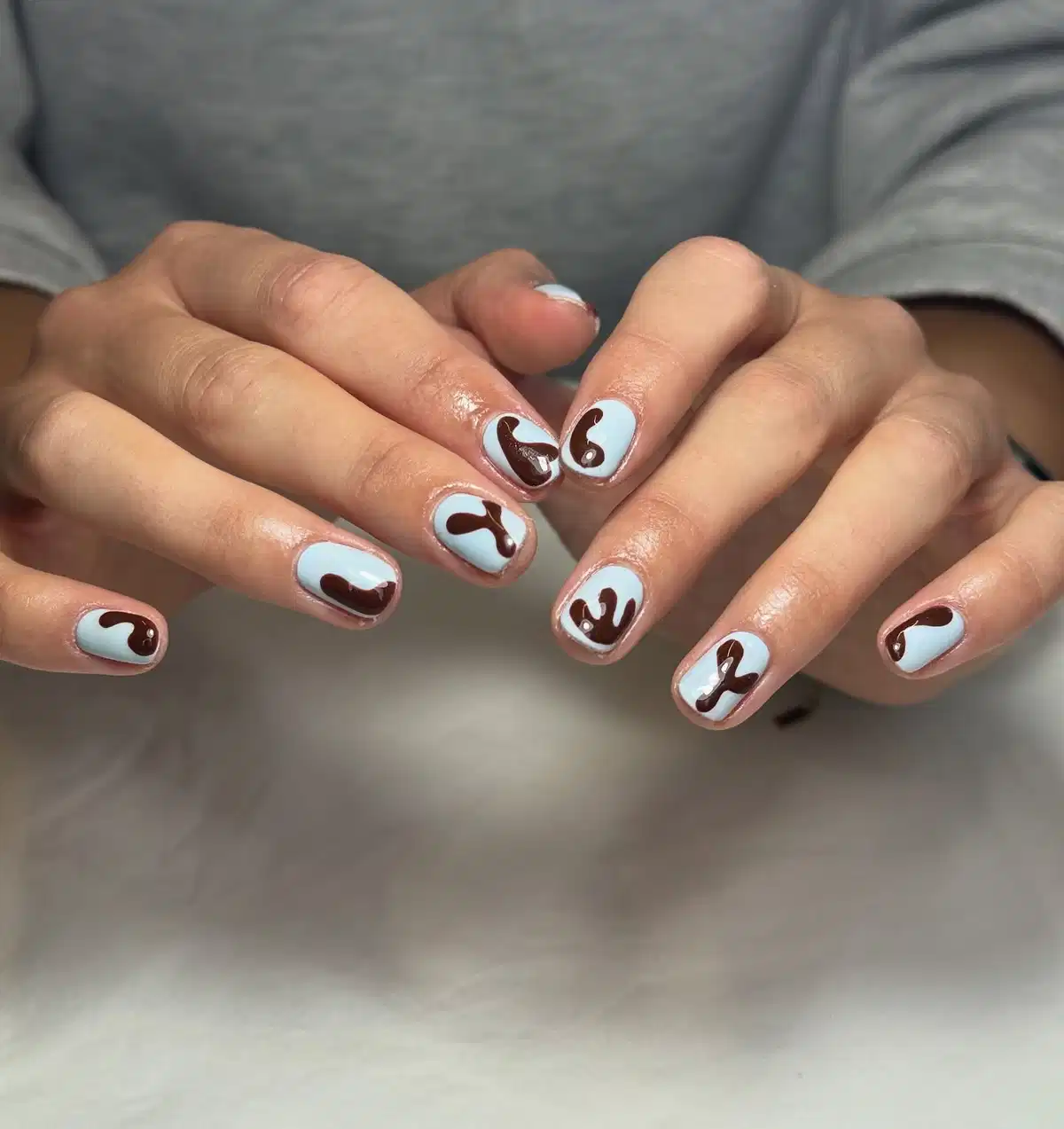 Light blue base with dark brown abstract blobs