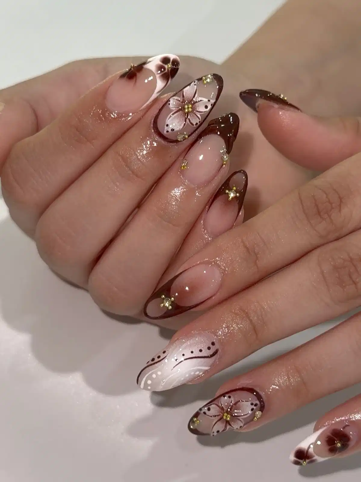 Brown tips with floral accents and gold studs