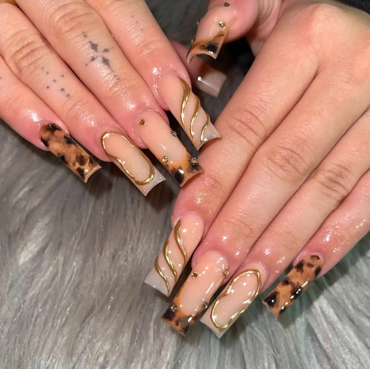 Extra-long nude squares with animal-print tips and raised gold waves