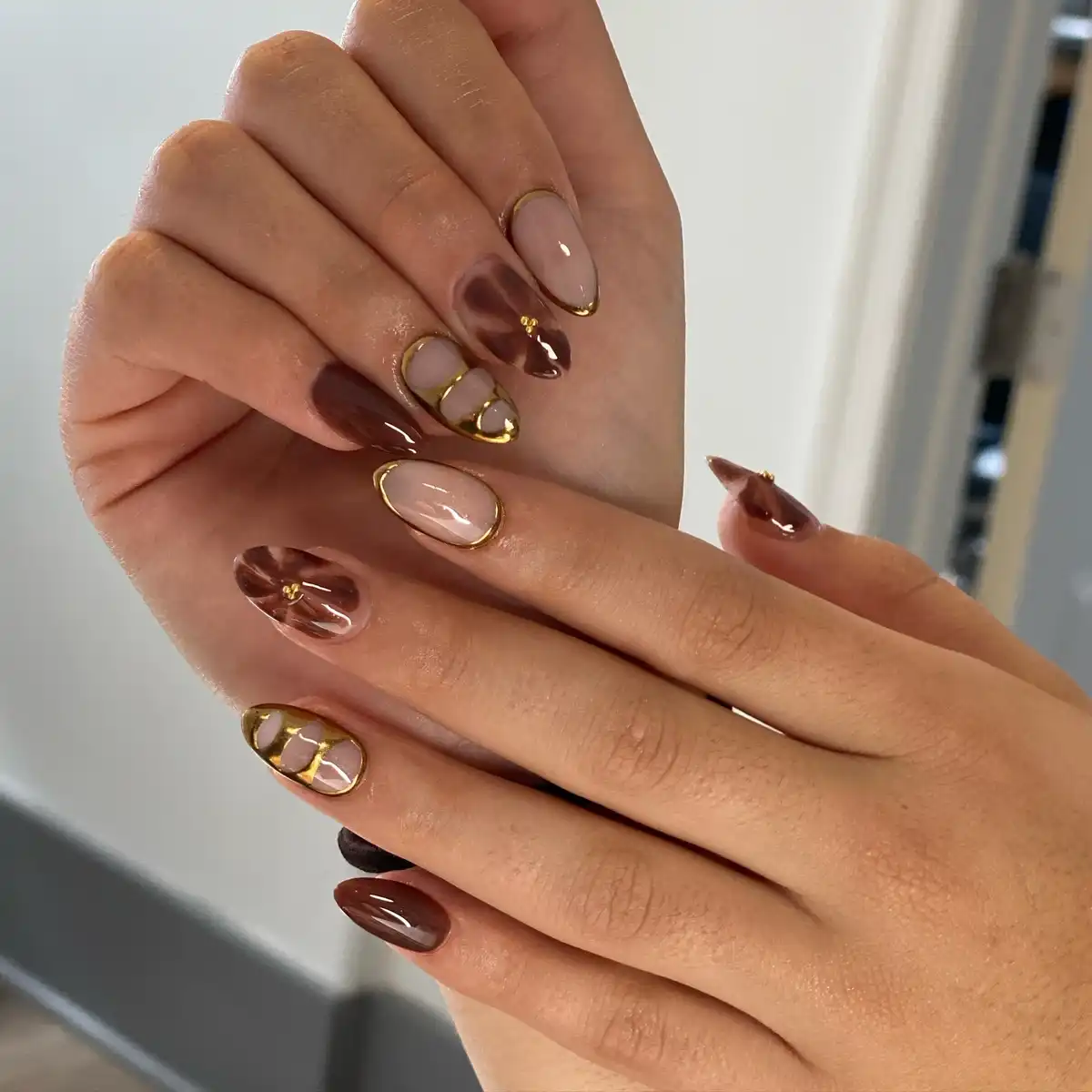Gold-outlined nude and brown swirls with small gold studs