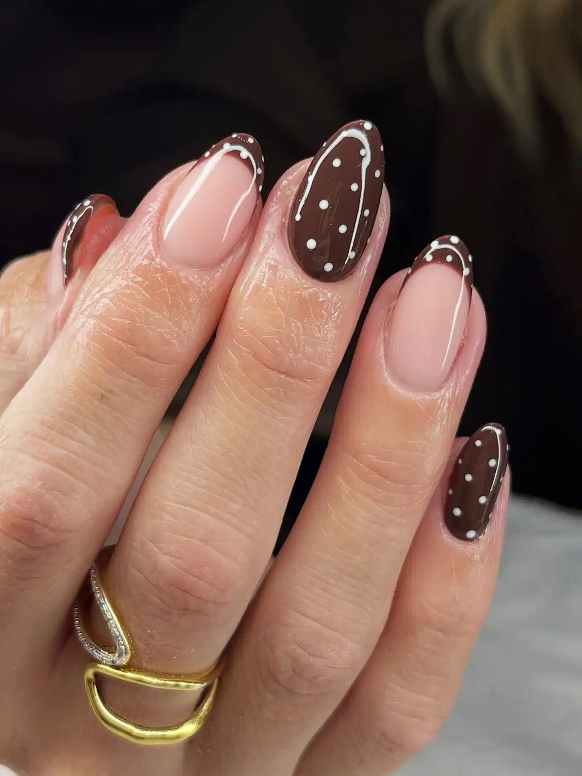 Nude base with brown French borders and dotted brown accent nails