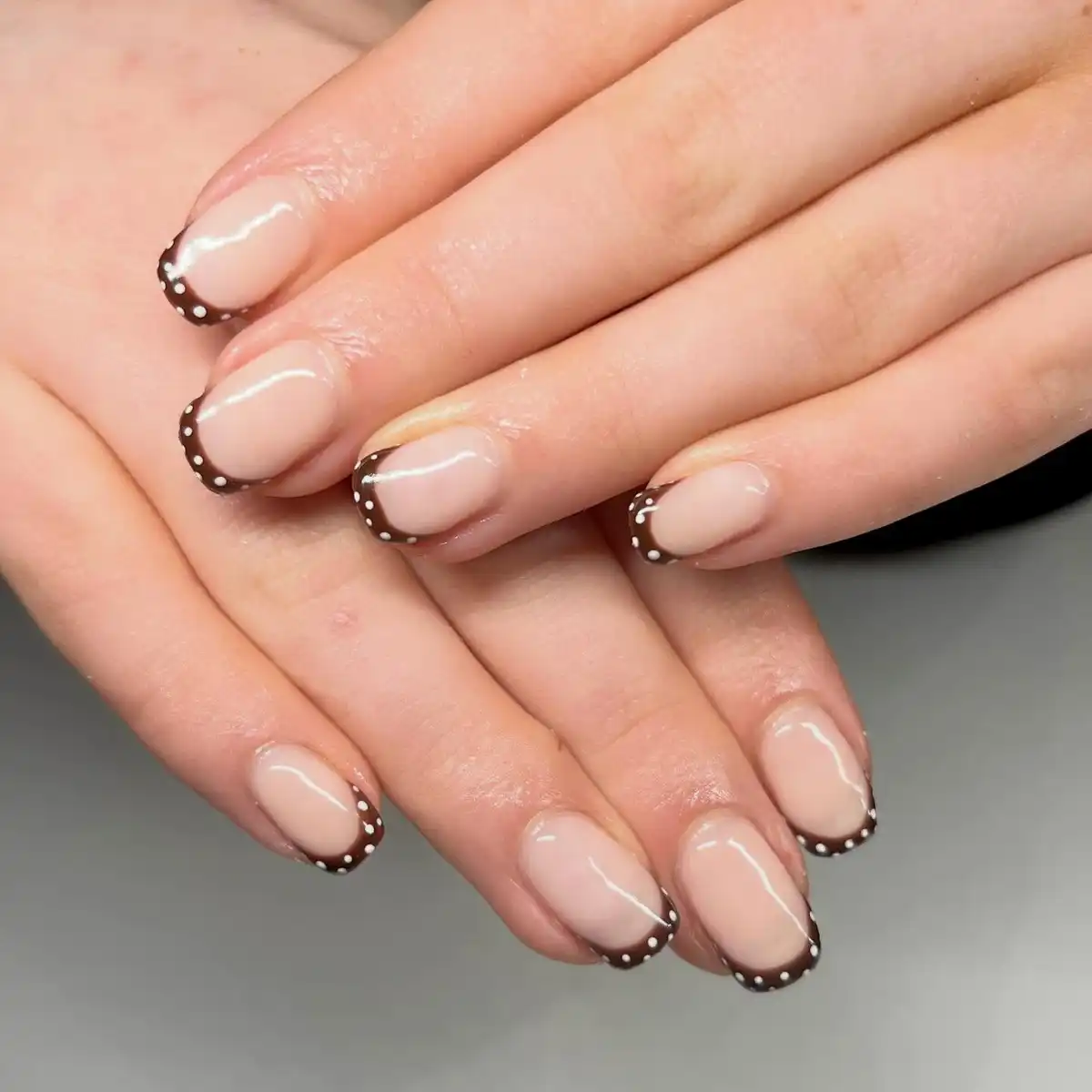 Thin brown French tips with white dotted edging