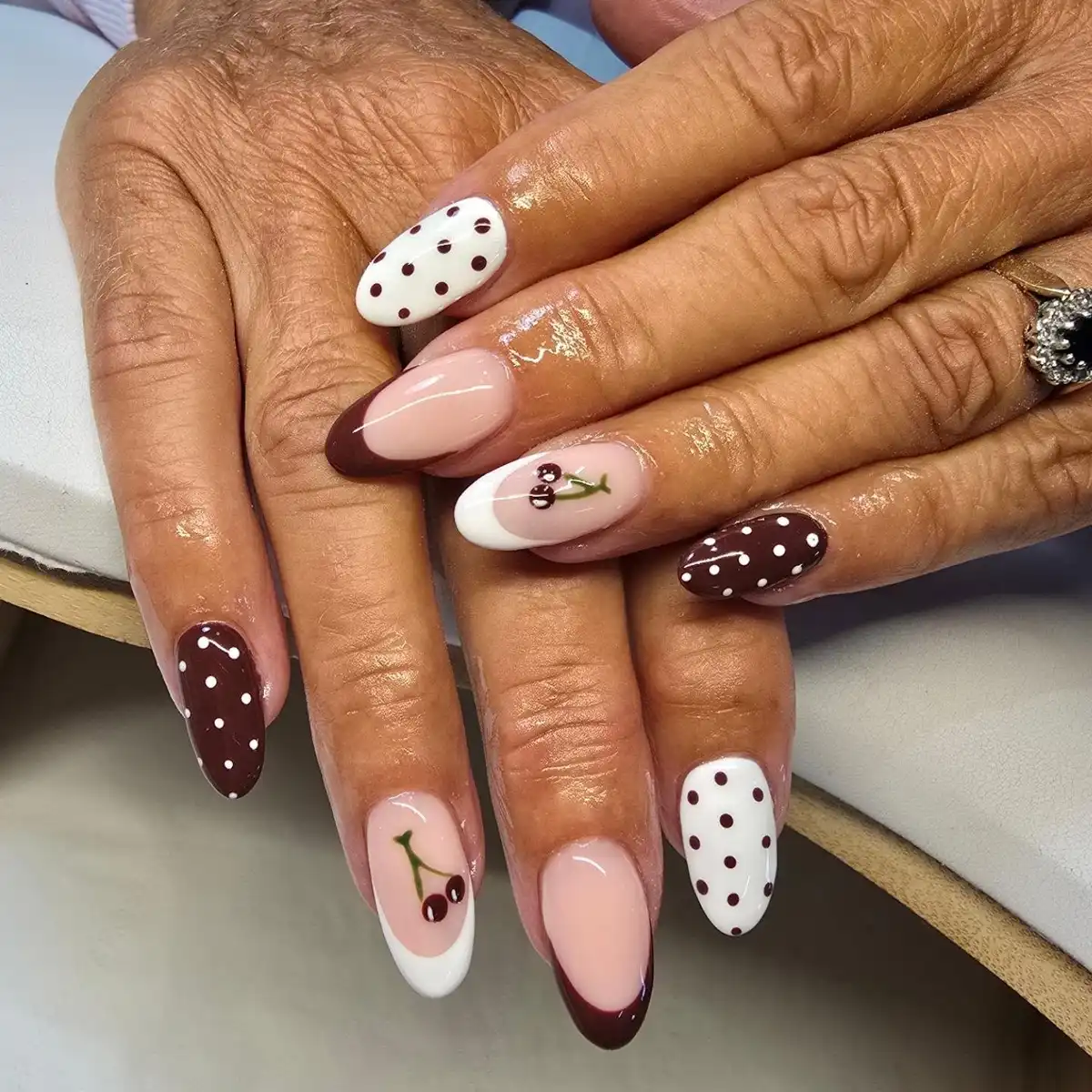 Brown French tips with polka dots and cherry accents