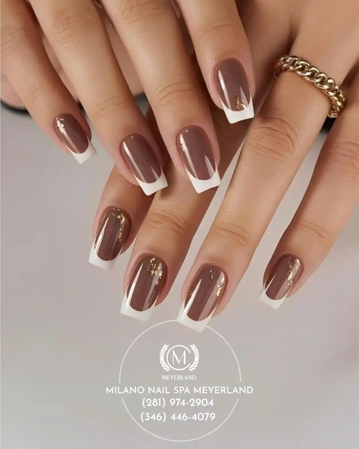 Brown base with white French tips and gold glitter streaks
