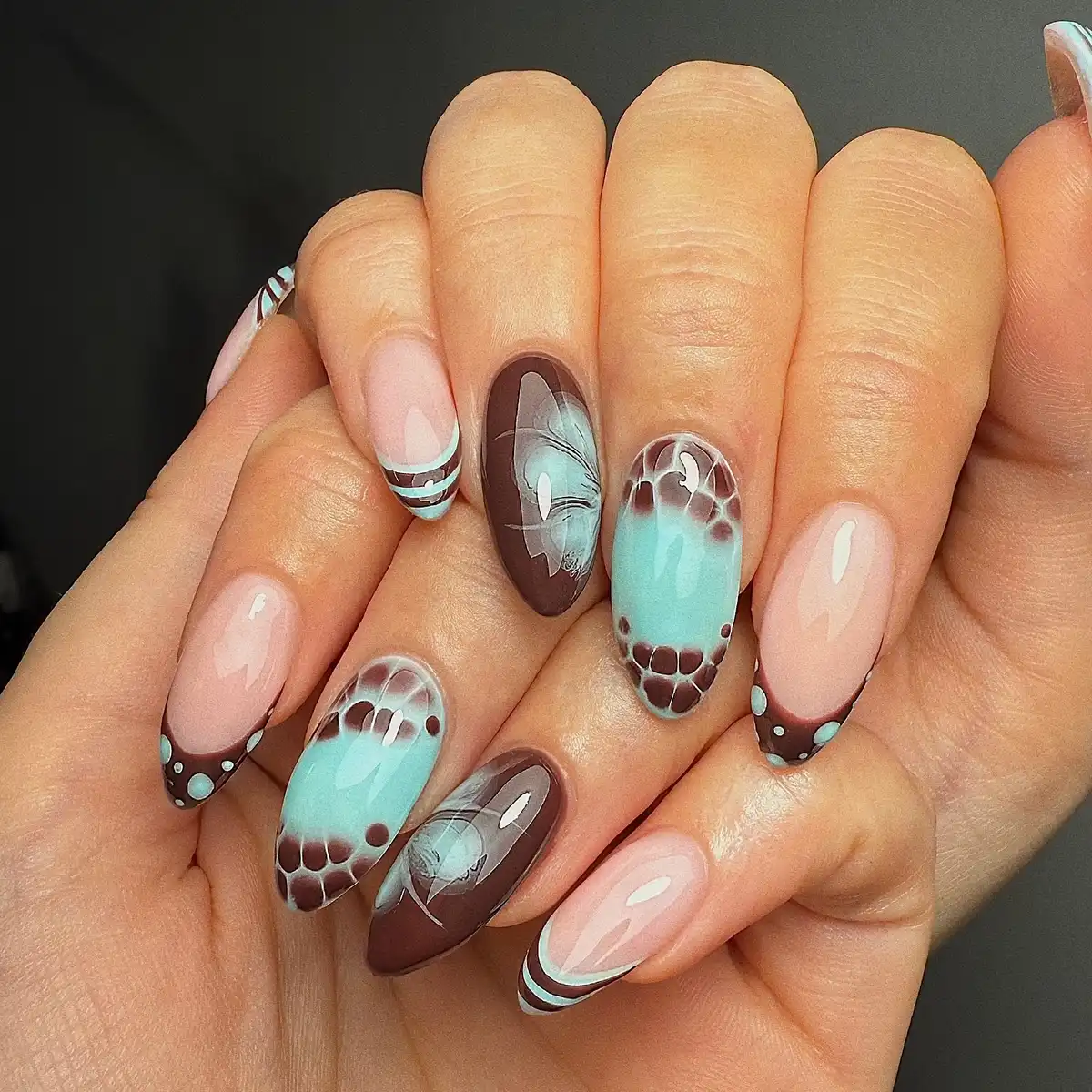 Brown French tips with light-blue panels and butterfly motifs