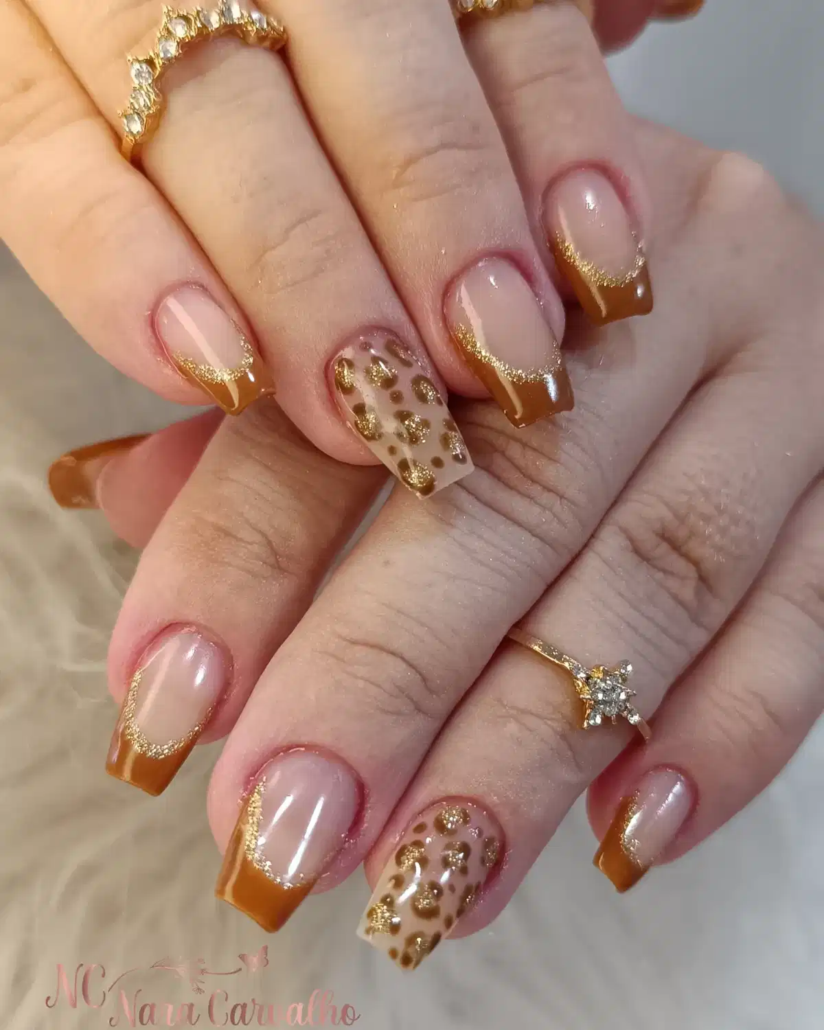 Caramel-brown French tips with gold glitter and spotted accents