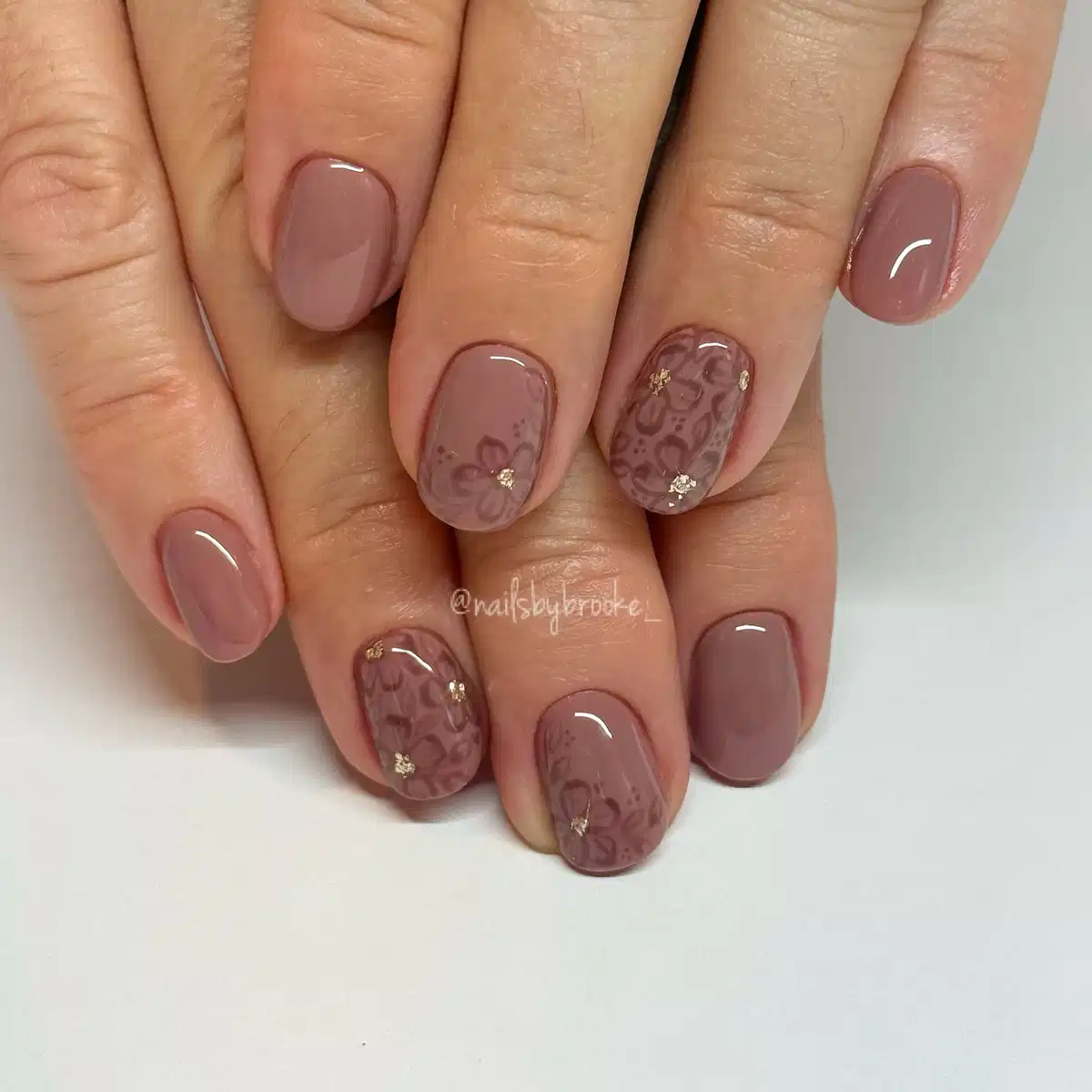 Muted taupe-brown with subtle floral overlay accents