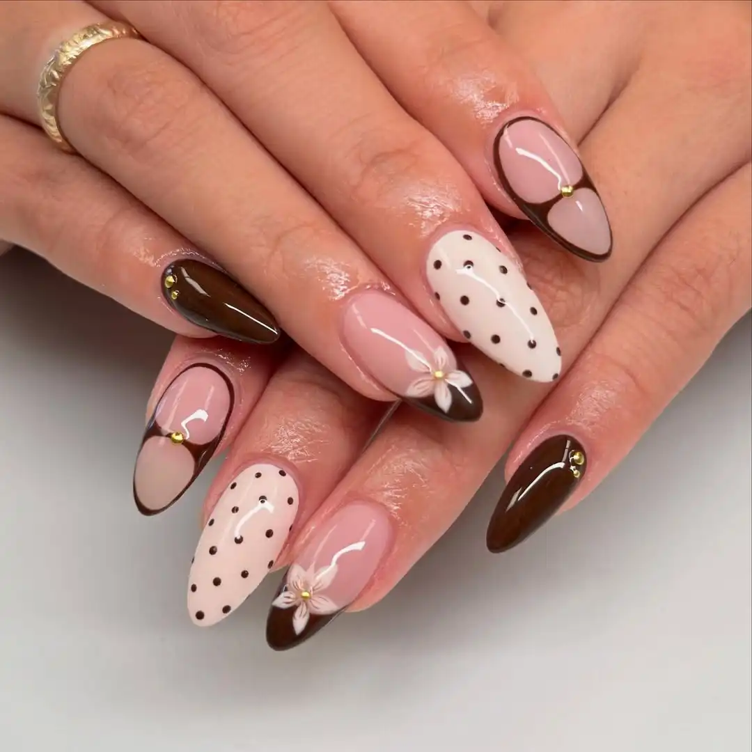 Brown French tips with polka dots and small floral detail